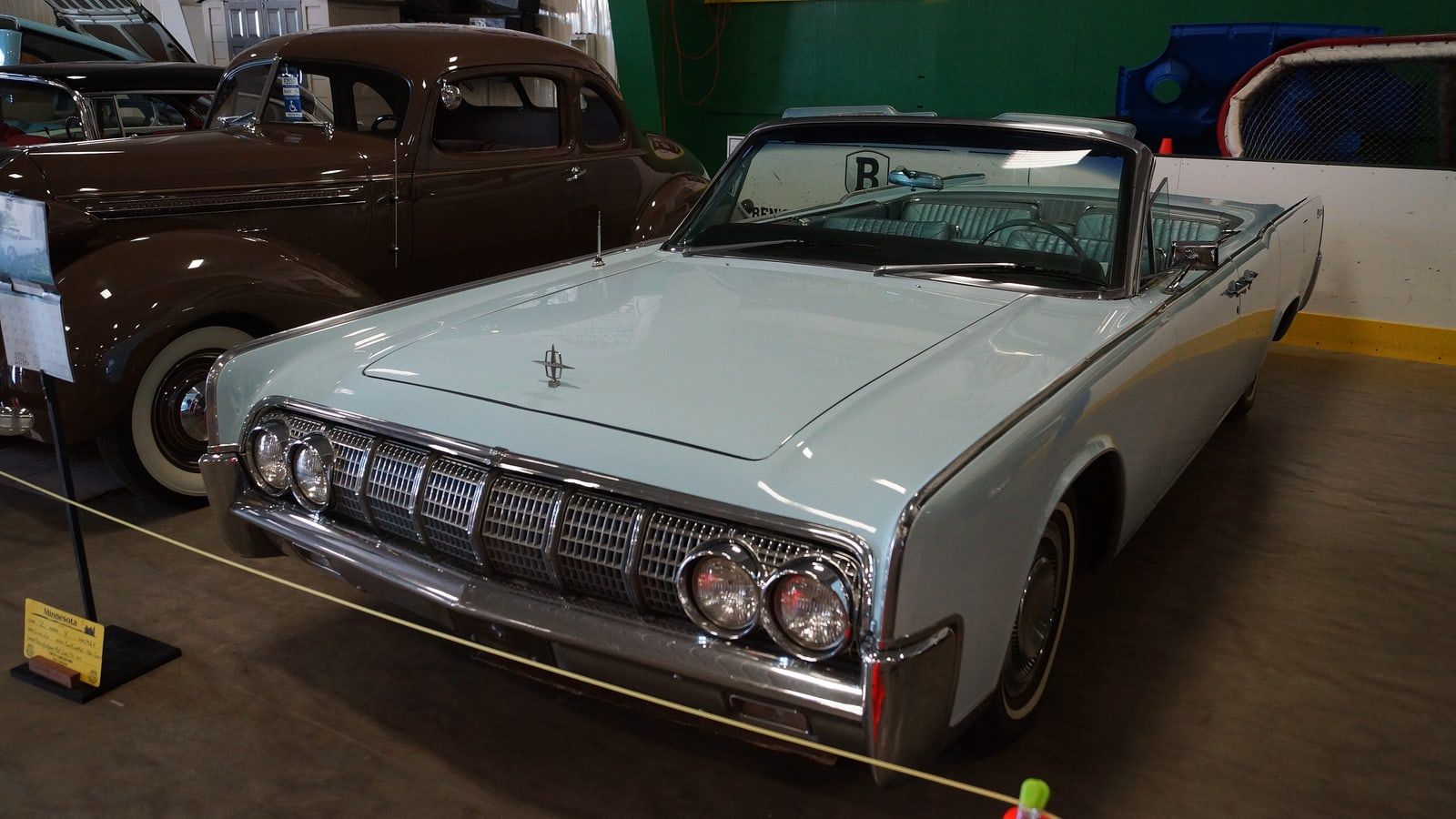 White 1964 Lincoln Continental convertible, front three-quarter view on indoor display