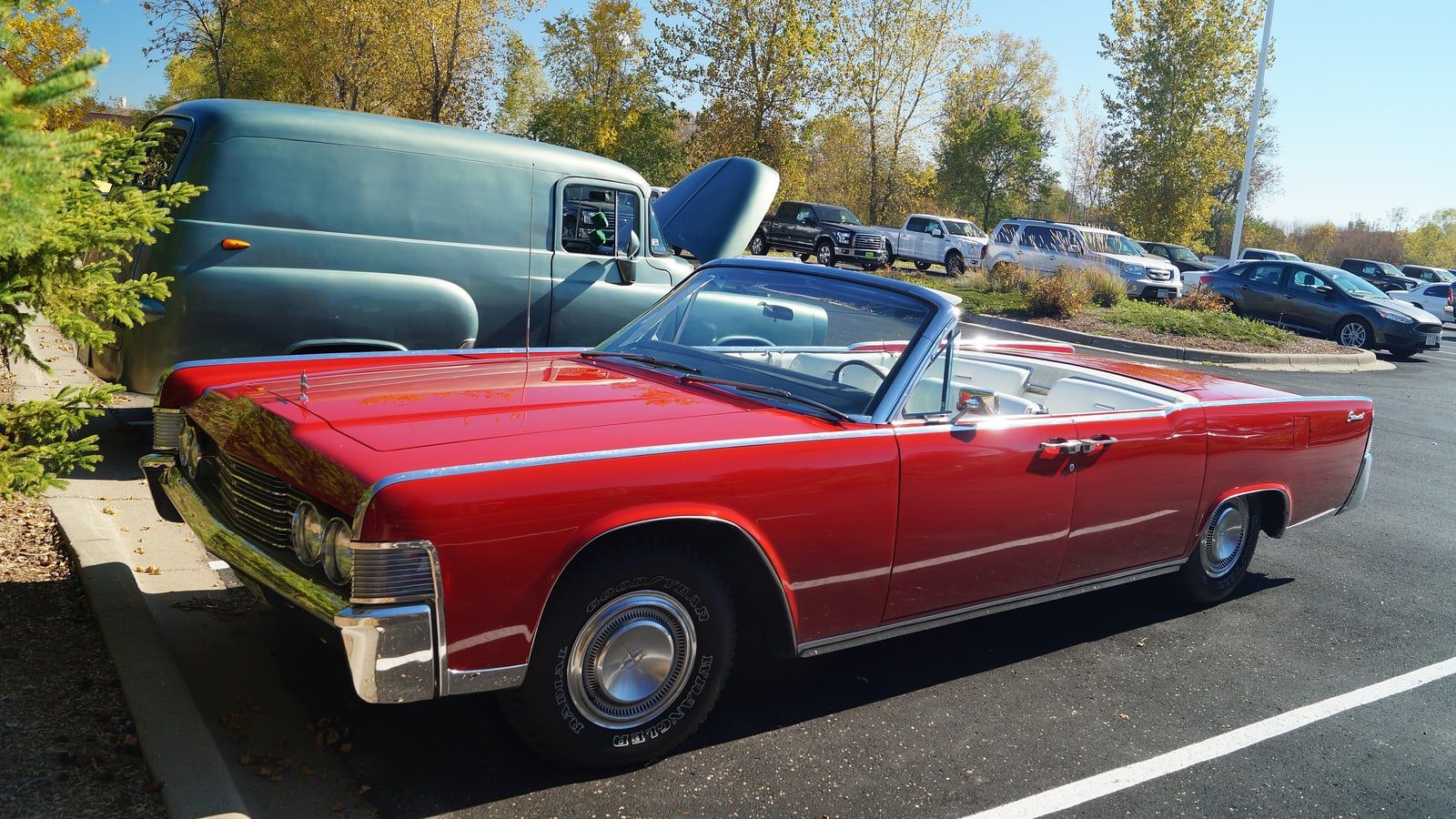 Red 1965 Lincoln Continental convertible with the top down, front three-quarter view