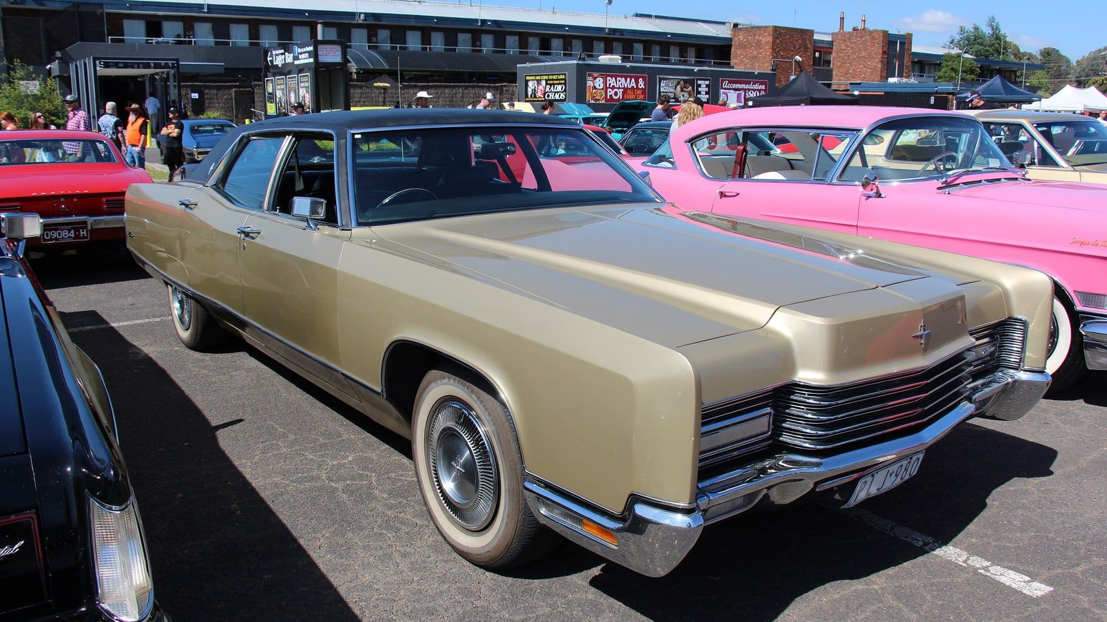 Gold 1970 Lincoln Continental sedan, front three-quarter view at a car show