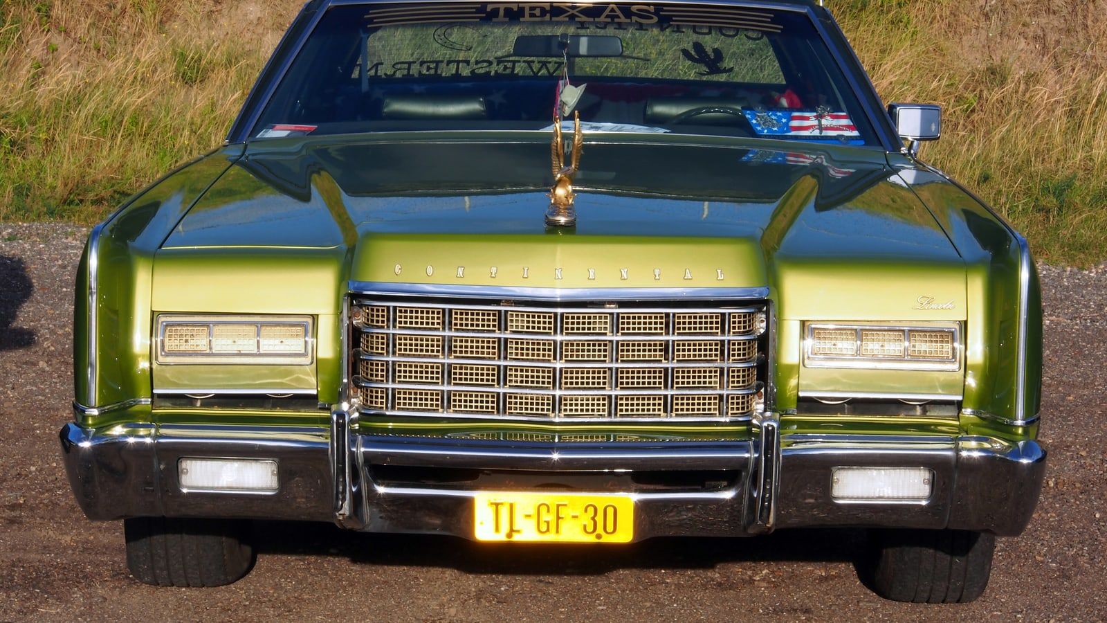 Green 1973 Lincoln Continental, head-on front view showing the full-width grille
