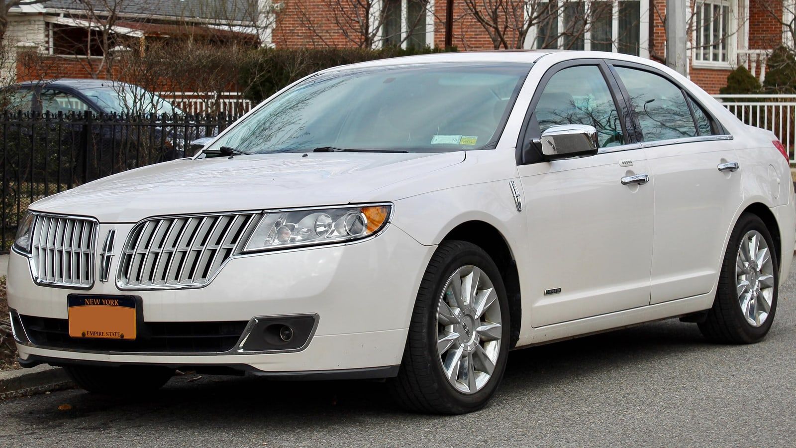 White 2012 Lincoln MKZ Hybrid, front three-quarter view showing the split-wing grille