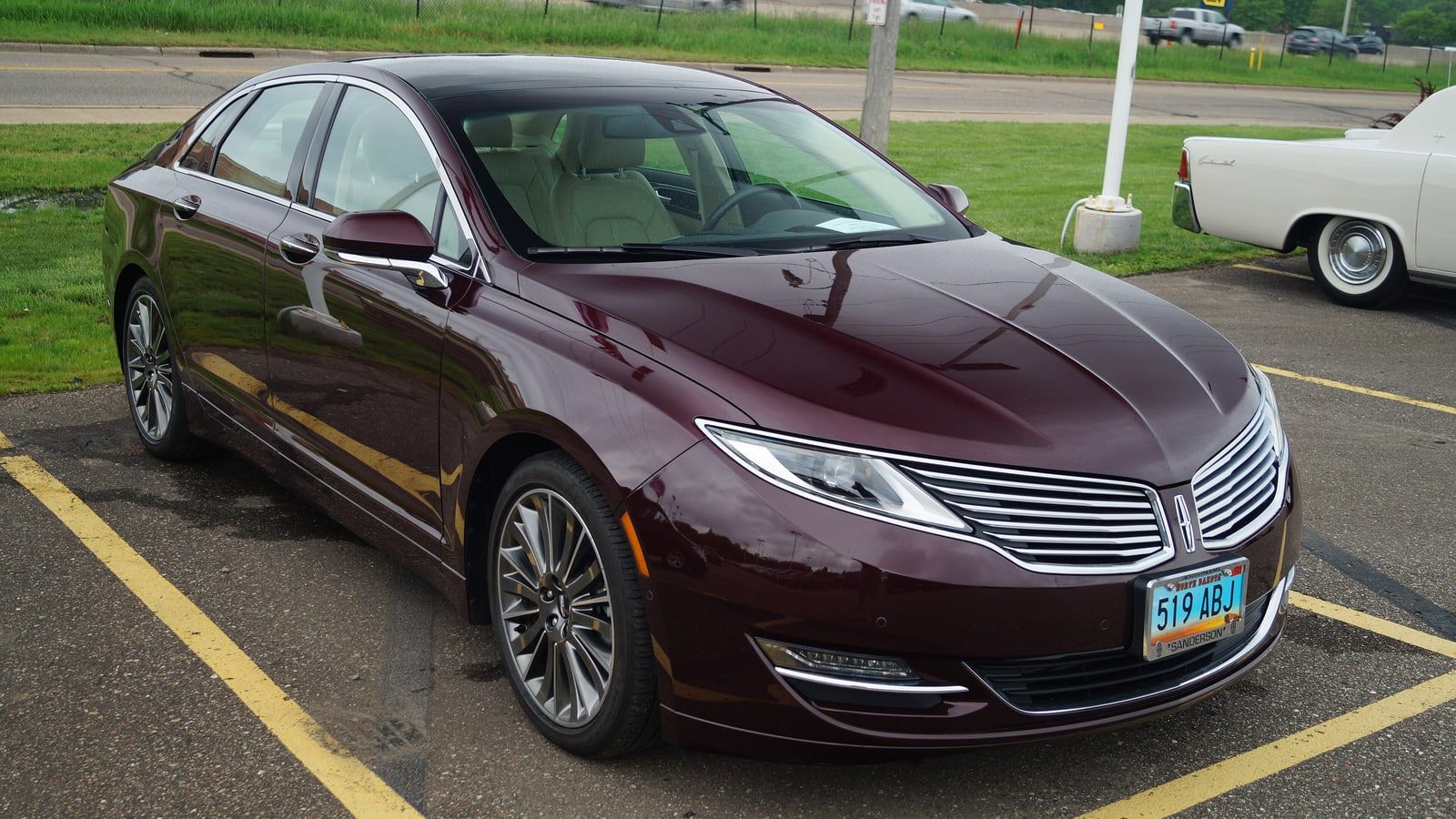 Maroon 2013 Lincoln MKZ, front three-quarter view in a parking lot