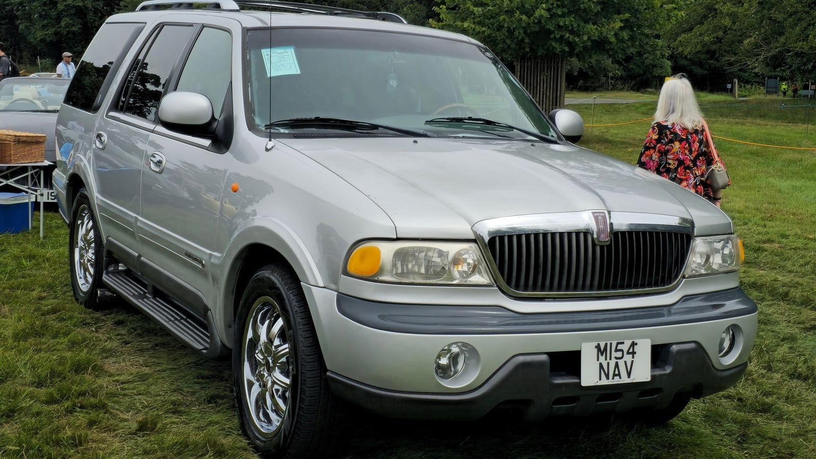 Silver first-generation Lincoln Navigator, front three-quarter view on grass