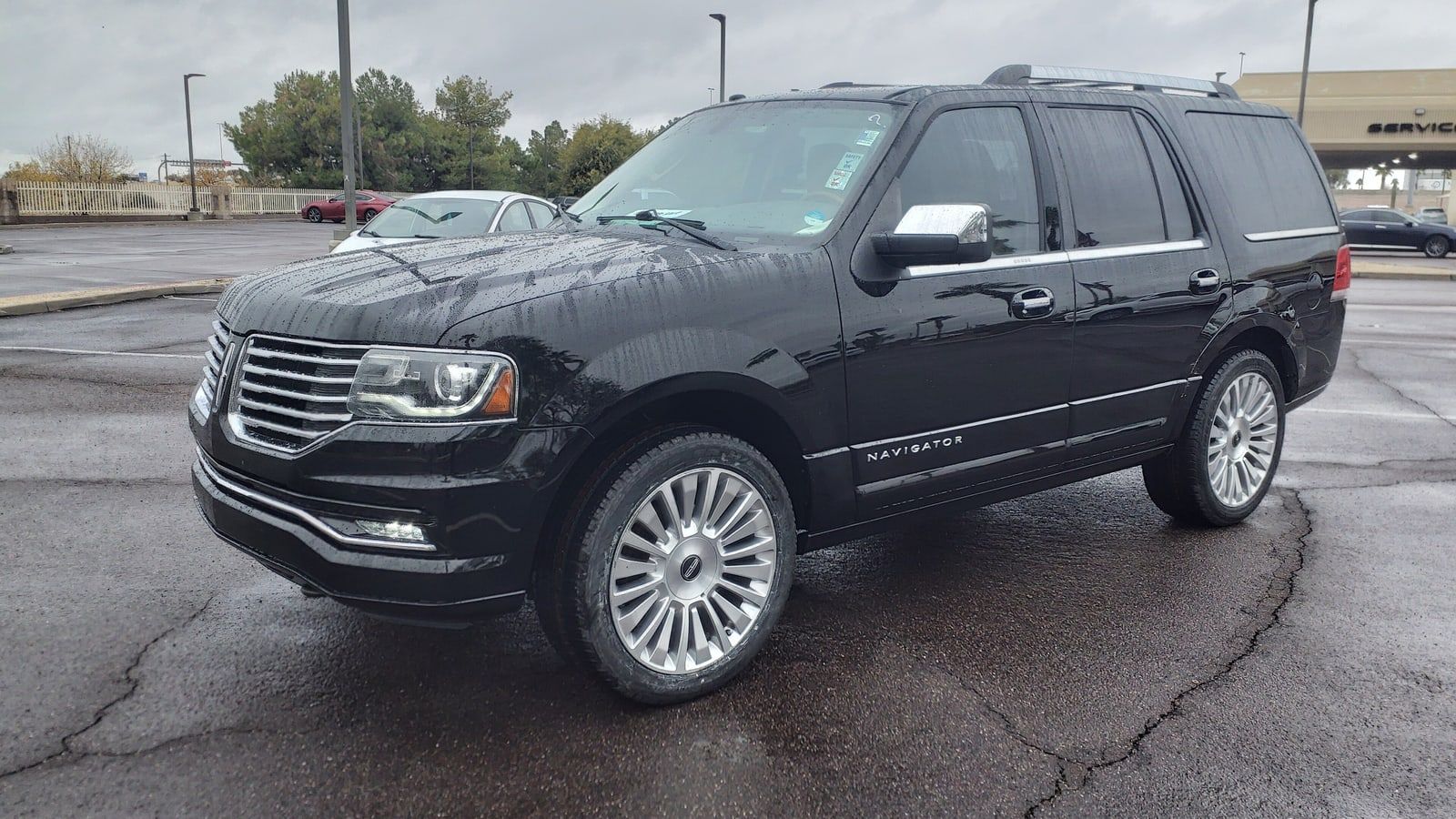 Black 2016 Lincoln Navigator, front three-quarter view in a parking lot