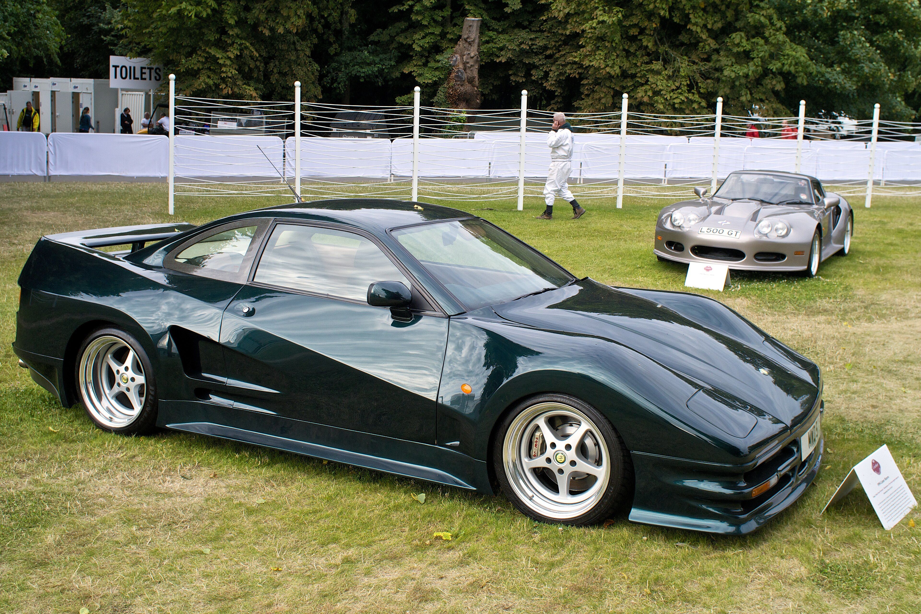 Dark green Lister Storm coupe, side profile