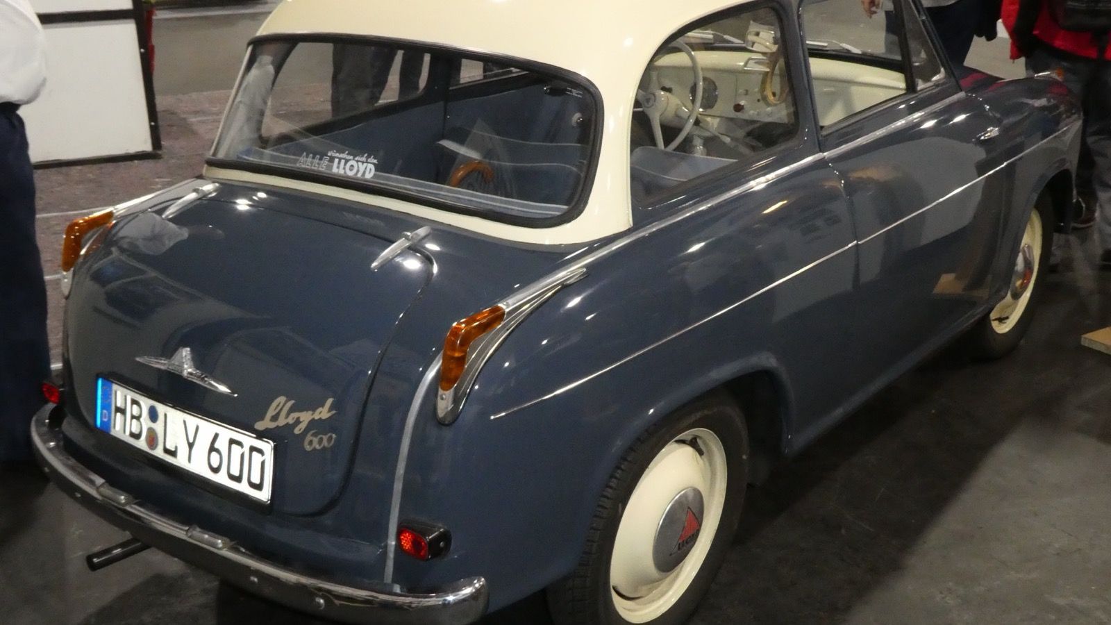 Two-tone blue and cream Lloyd 600 saloon at an indoor classic car show, rear three-quarter view