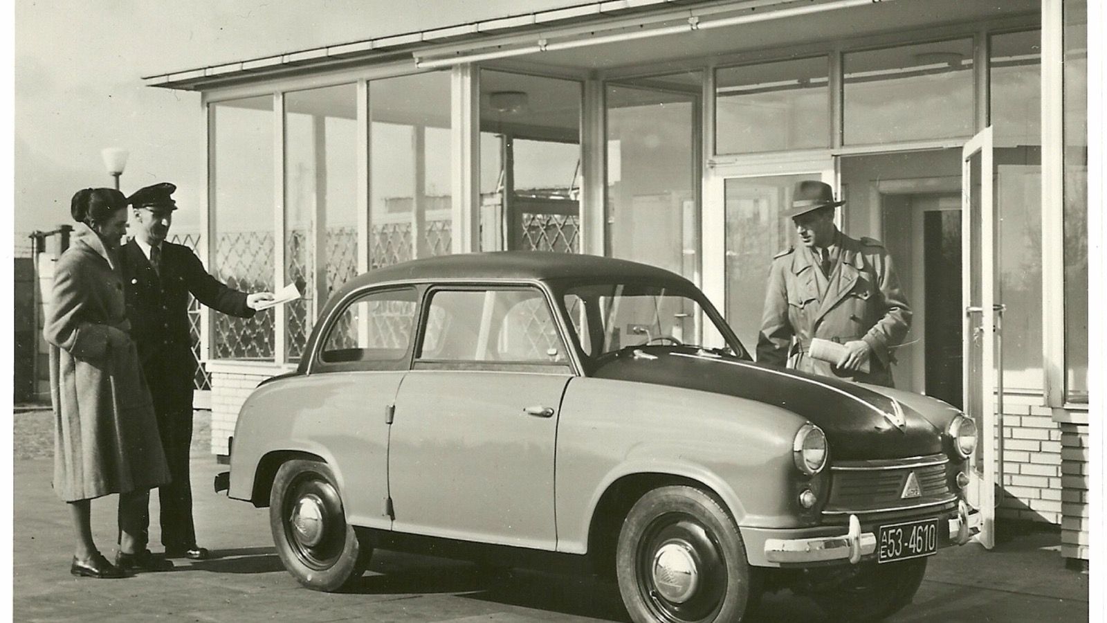 Two-tone 1953 Lloyd LP 400 saloon outside a showroom in a period photograph, front three-quarter view