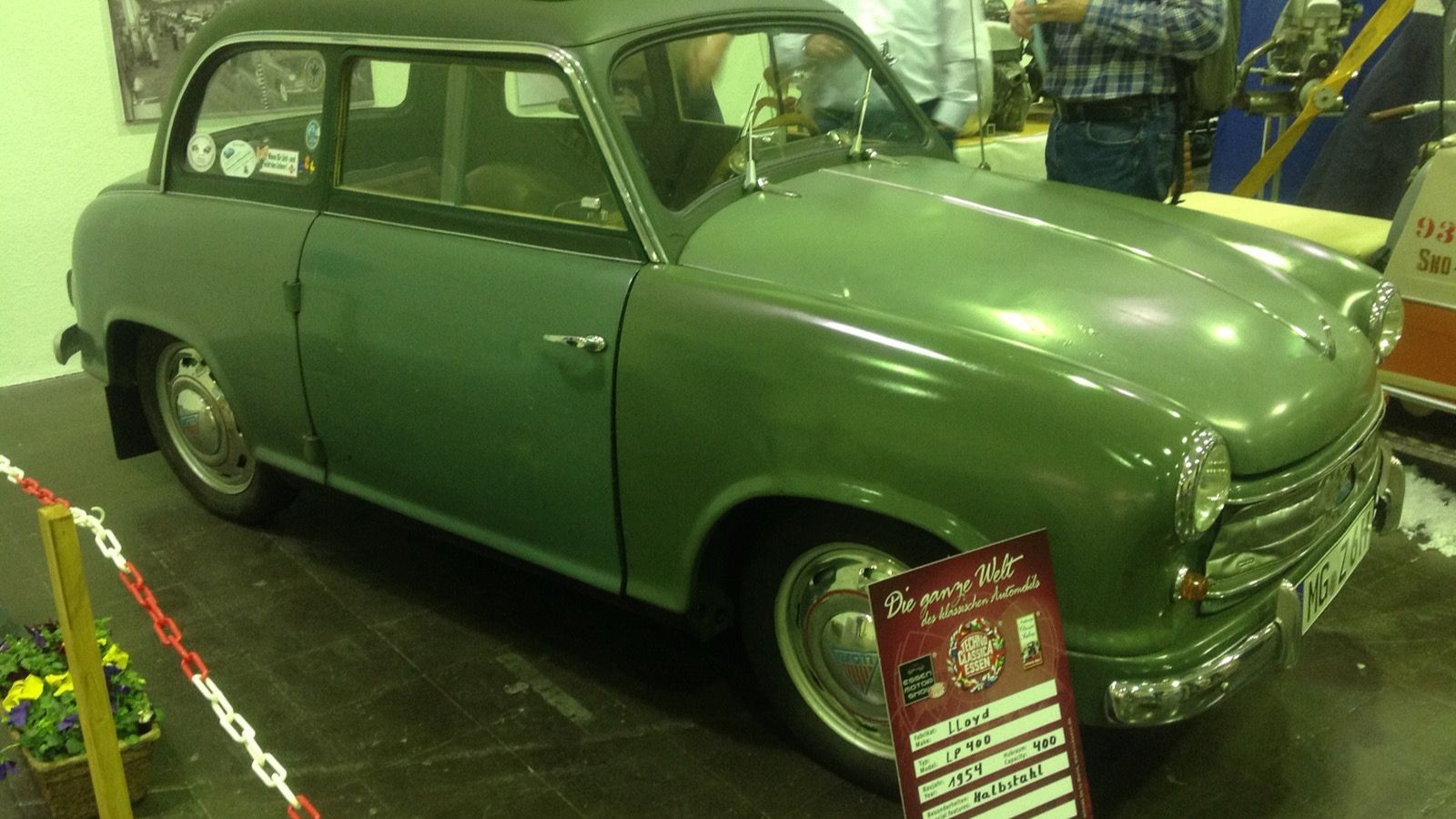 Green 1954 Lloyd LP 400 at an indoor classic car show, front three-quarter view