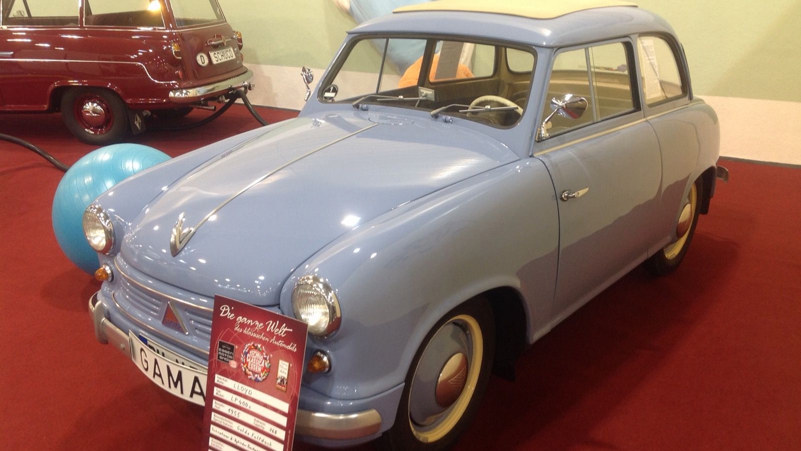 Pale blue 1955 Lloyd LP 400 S with folding sunroof on show display, front three-quarter view