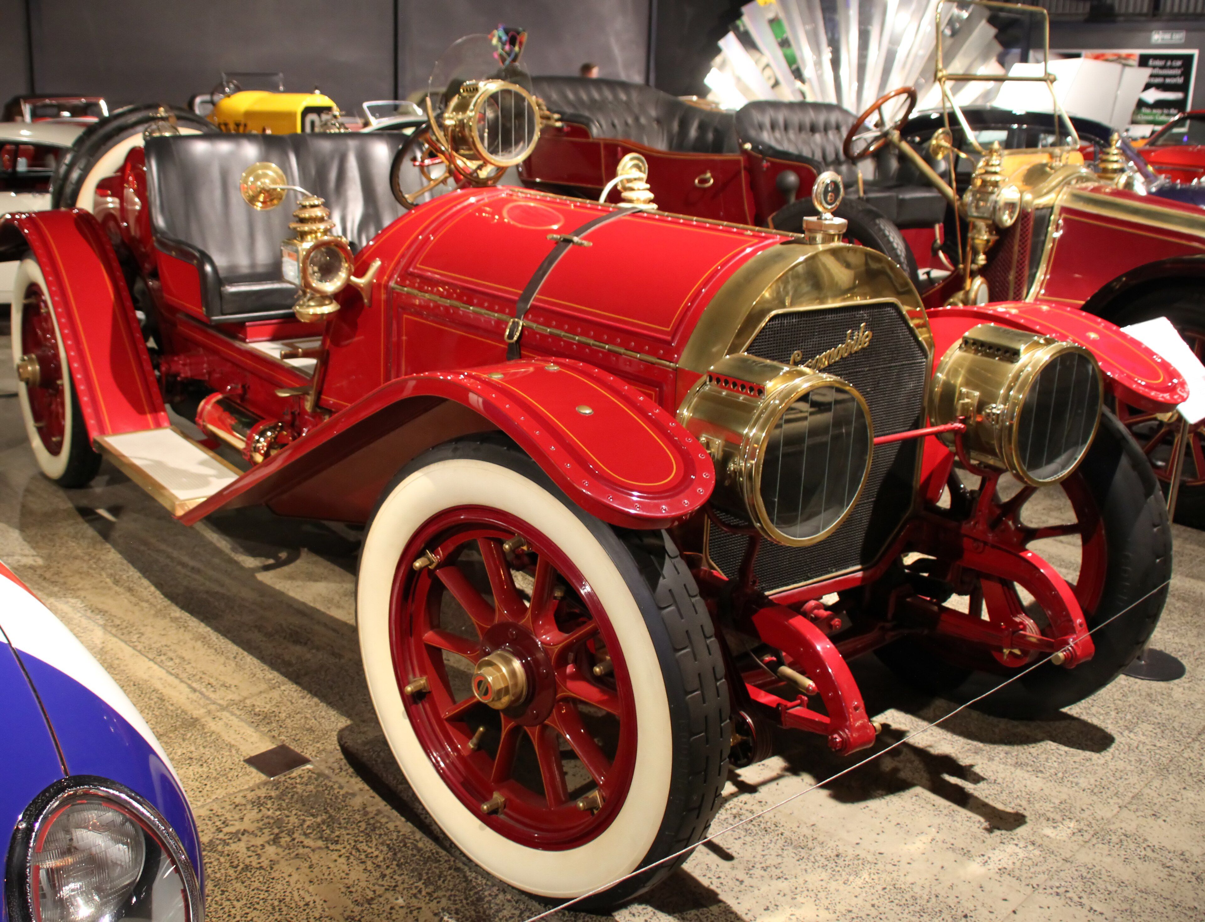 Red 1916 Locomobile Model 48 Speedster with brass fittings, front three-quarter view