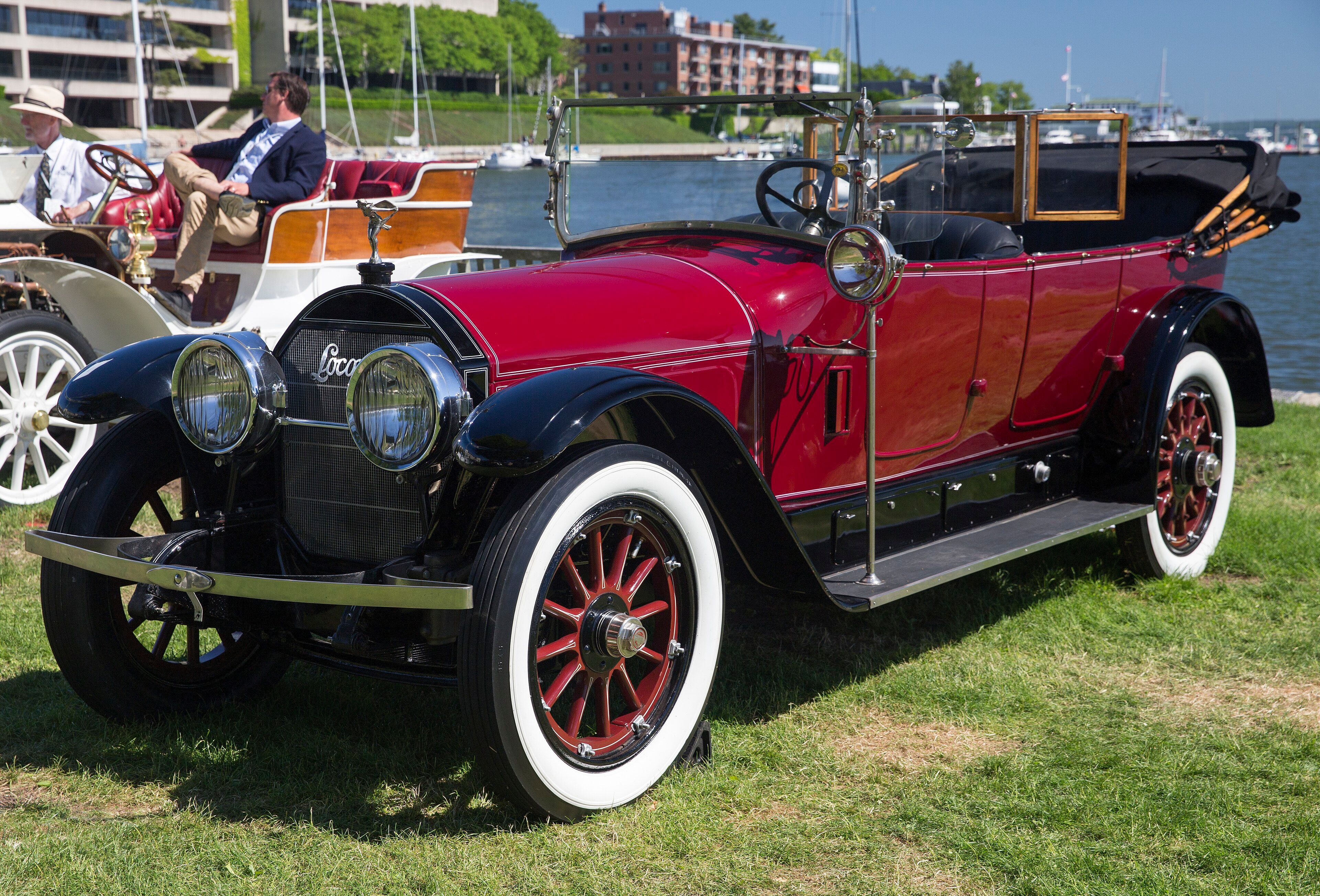 Maroon 1923 Locomobile Model 48 touring car with whitewall tyres, front three-quarter view