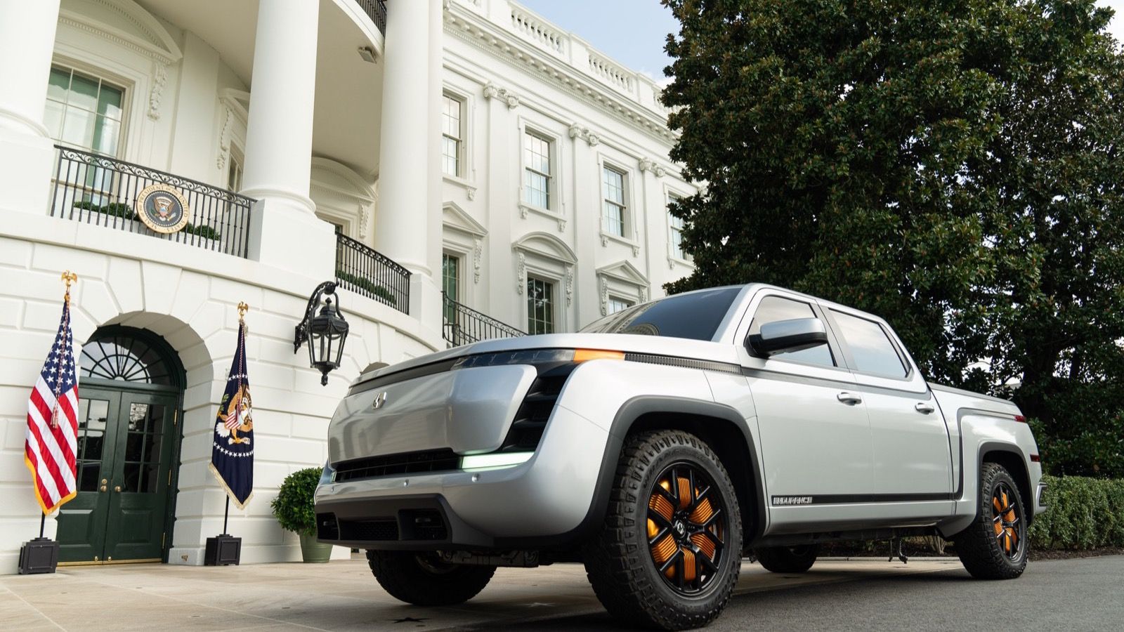 Silver pre-production Lordstown Endurance electric crew-cab pickup with orange in-wheel hub motors, front three-quarter view at the White House in September 2020