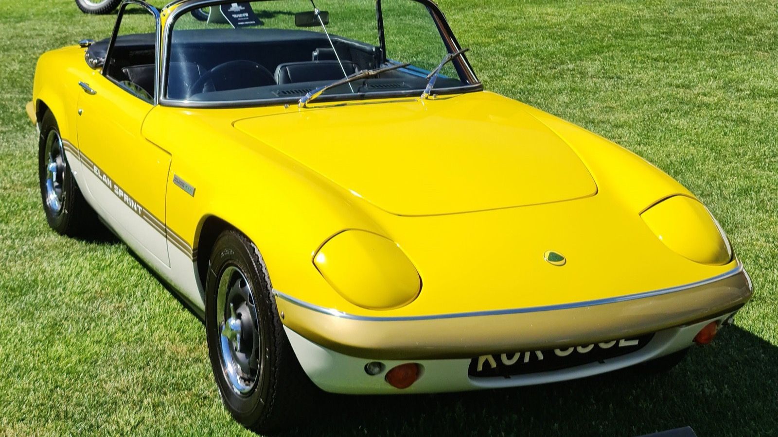 Yellow 1973 Lotus Elan Sprint drophead coupe, front three-quarter view.