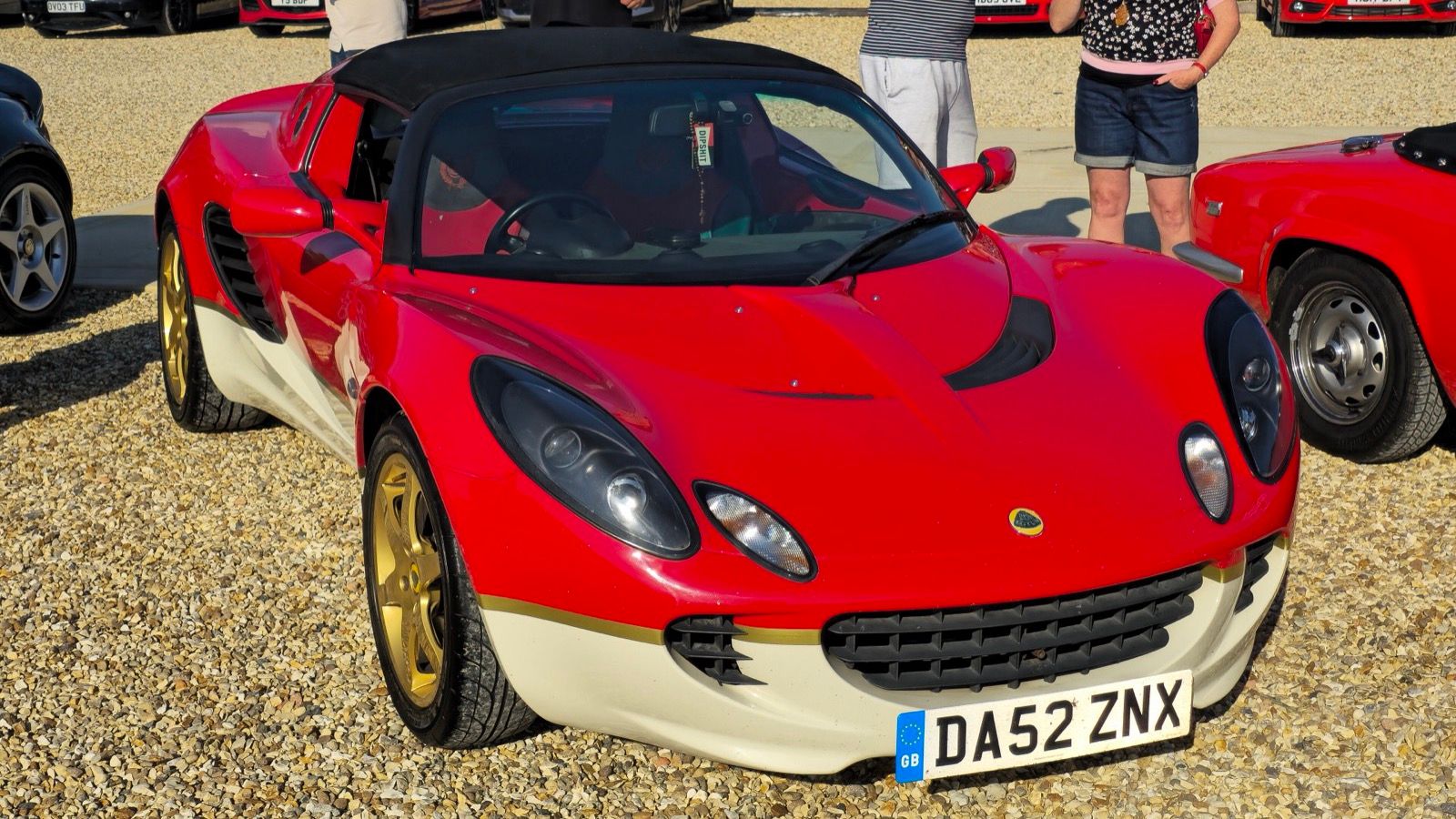 Red and cream 2003 Lotus Elise Type 49, front three-quarter view.