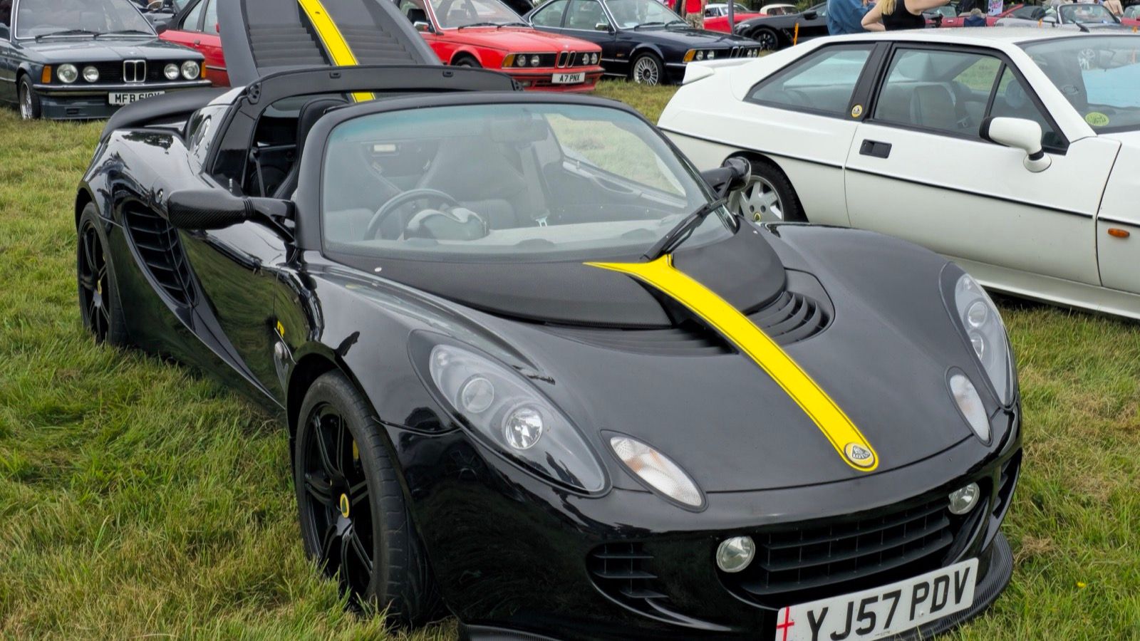 Black 2007 Lotus Elise R with yellow stripe, front three-quarter view.