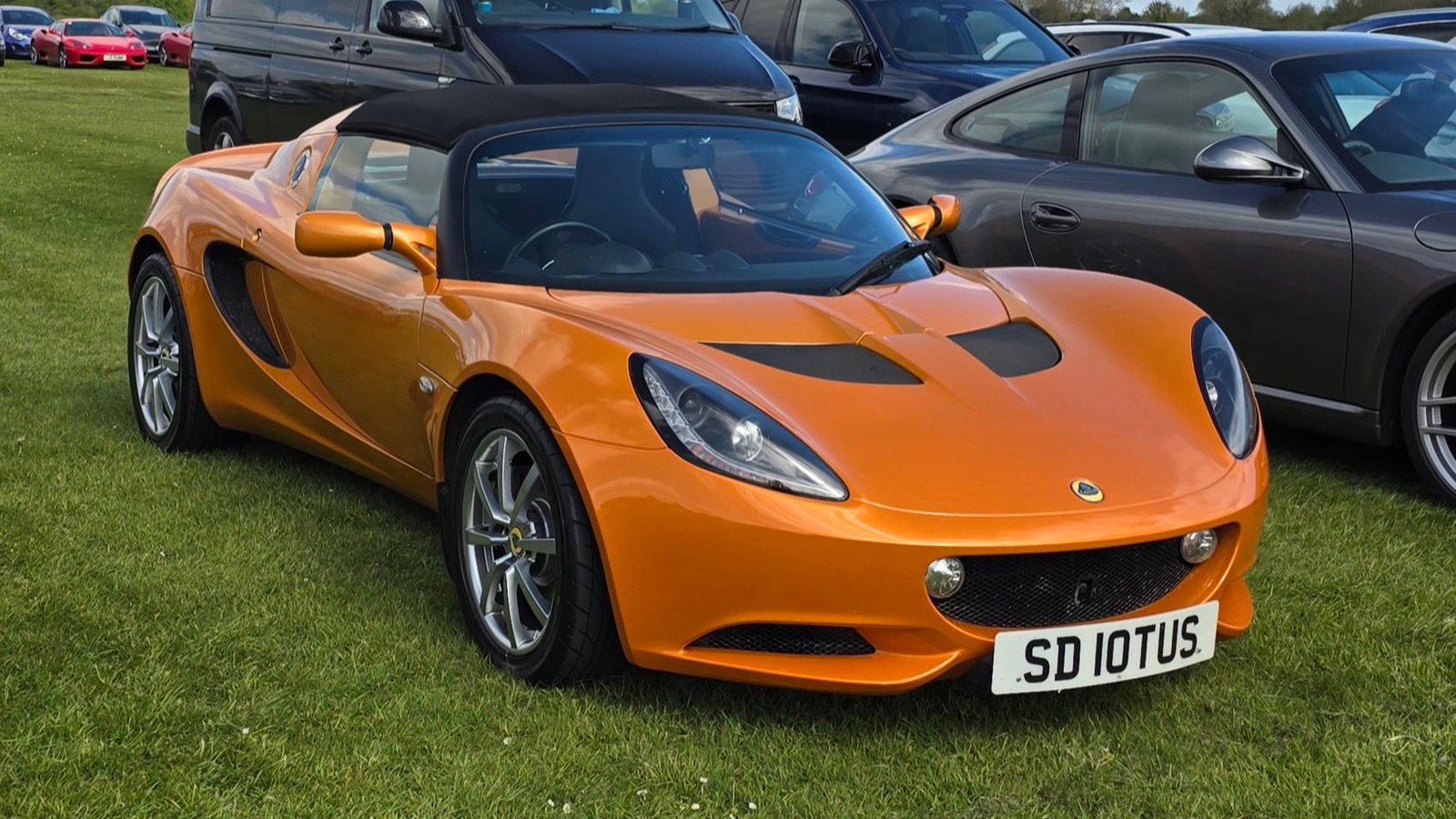 Orange 2010 Lotus Elise R Touring, front three-quarter view.