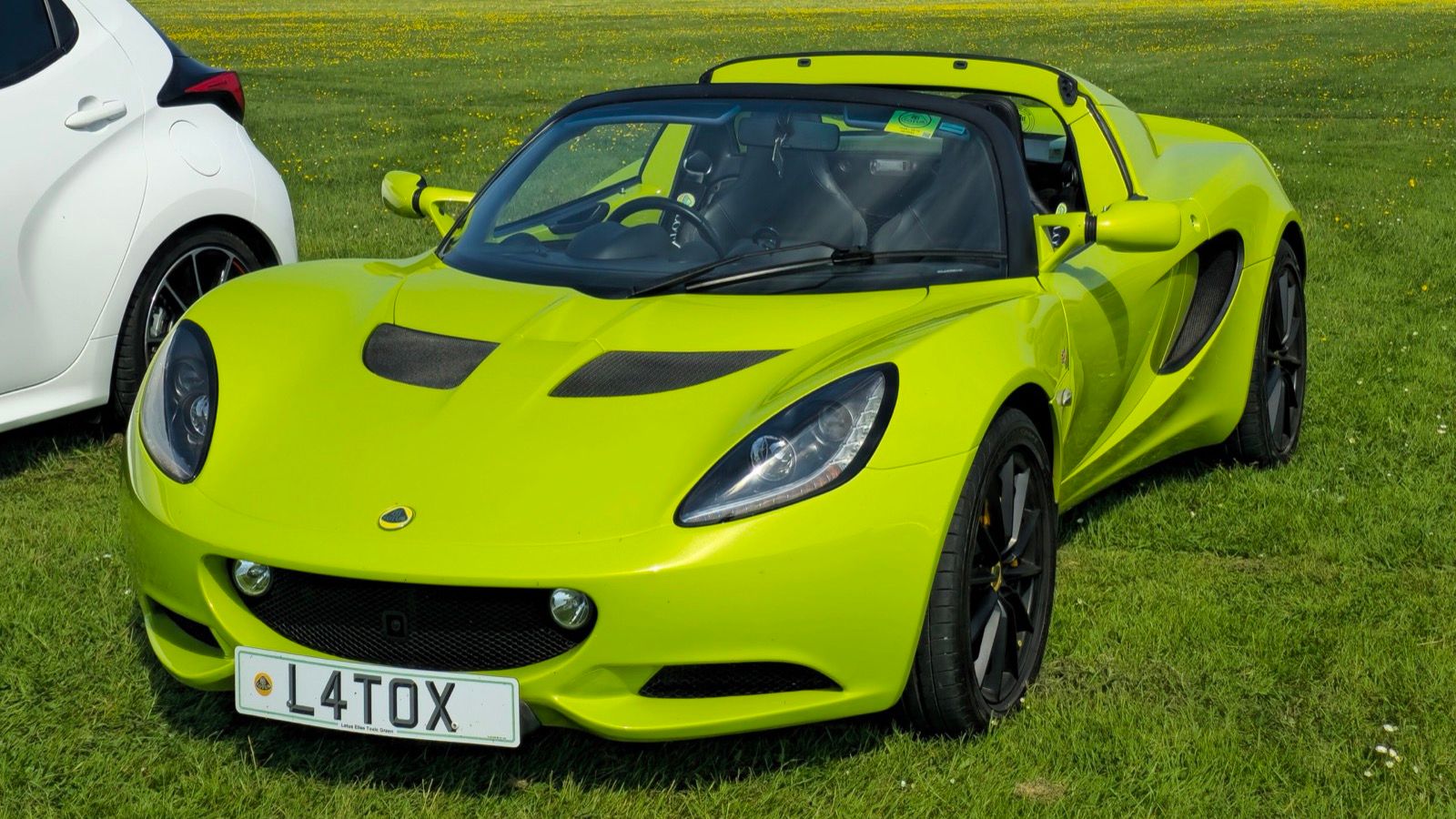 Lime green 2015 Lotus Elise, front three-quarter view.
