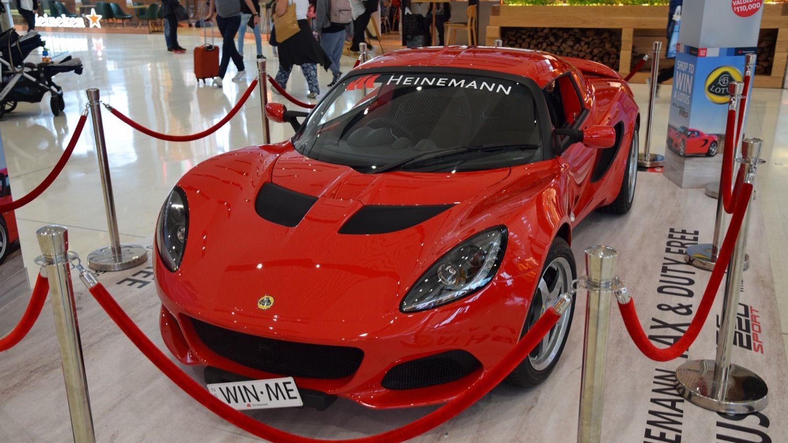 Red 2018 Lotus Elise on indoor display, front three-quarter view.