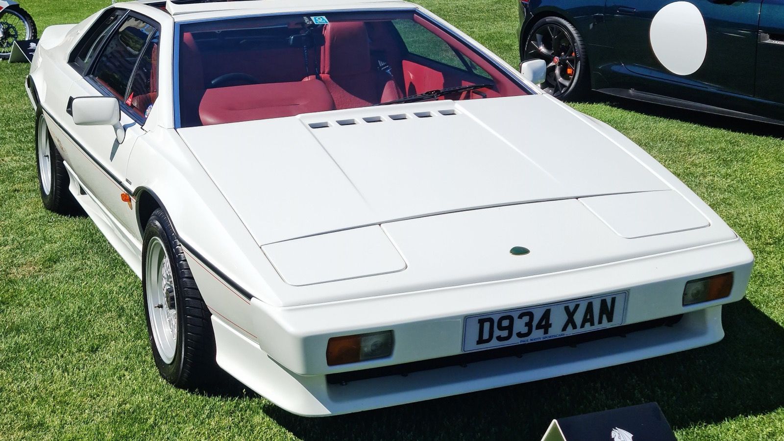 White 1987 Lotus Esprit Turbo HC with red interior, front three-quarter view.