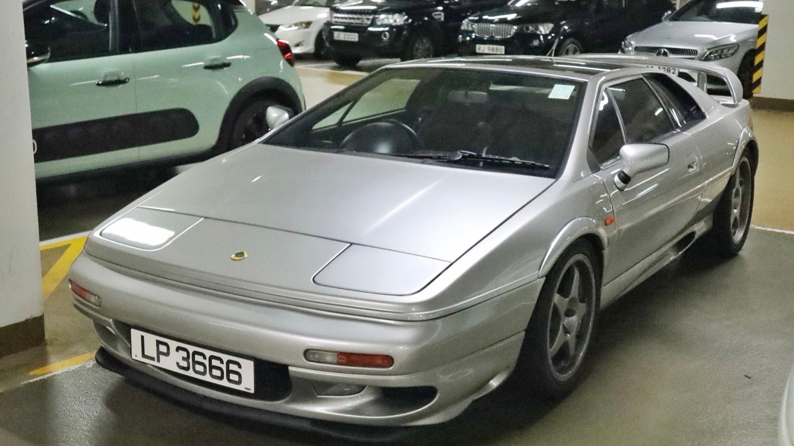 Silver 2001 Lotus Esprit V8, front three-quarter view.