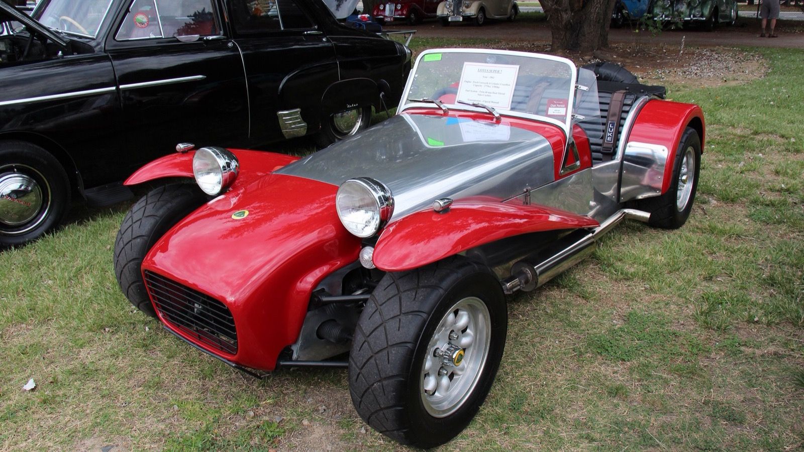 Red and aluminium 1962 Lotus Super Seven Series 2, front three-quarter view.