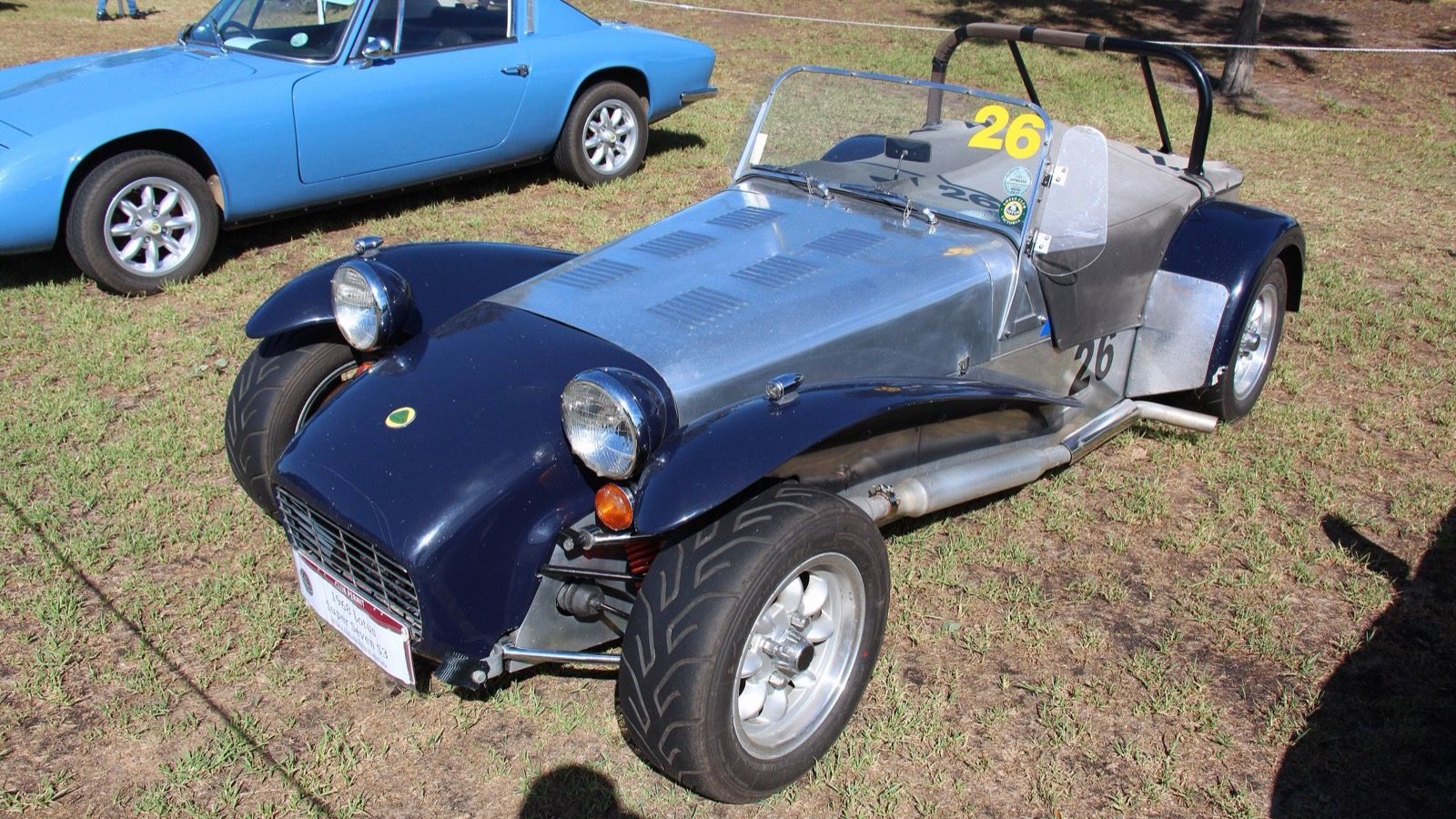 Dark blue 1968 Lotus Super Seven Series 3 at a car show, front three-quarter view.
