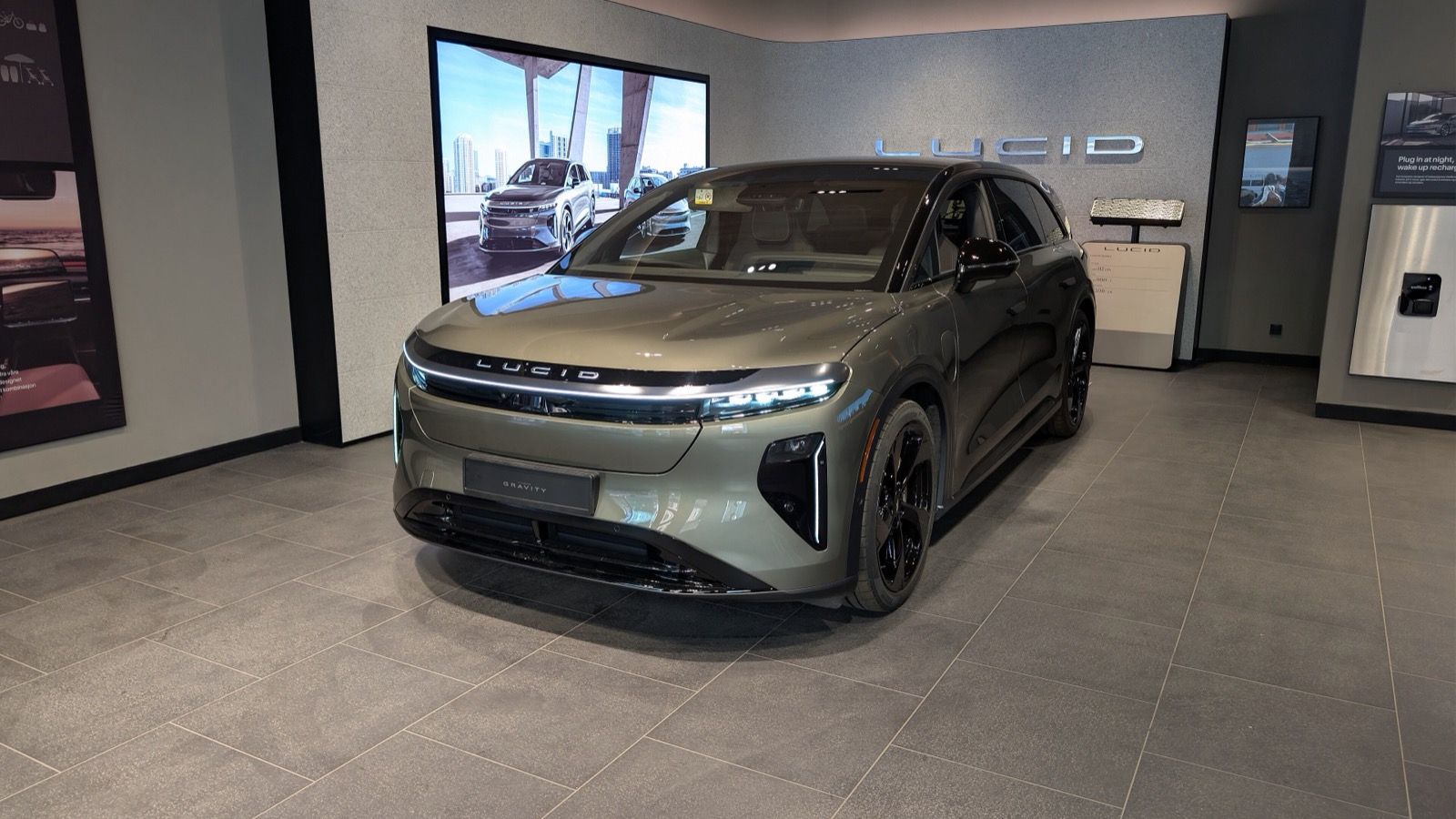 Green Lucid Gravity SUV on display in a Lucid showroom, front three-quarter view