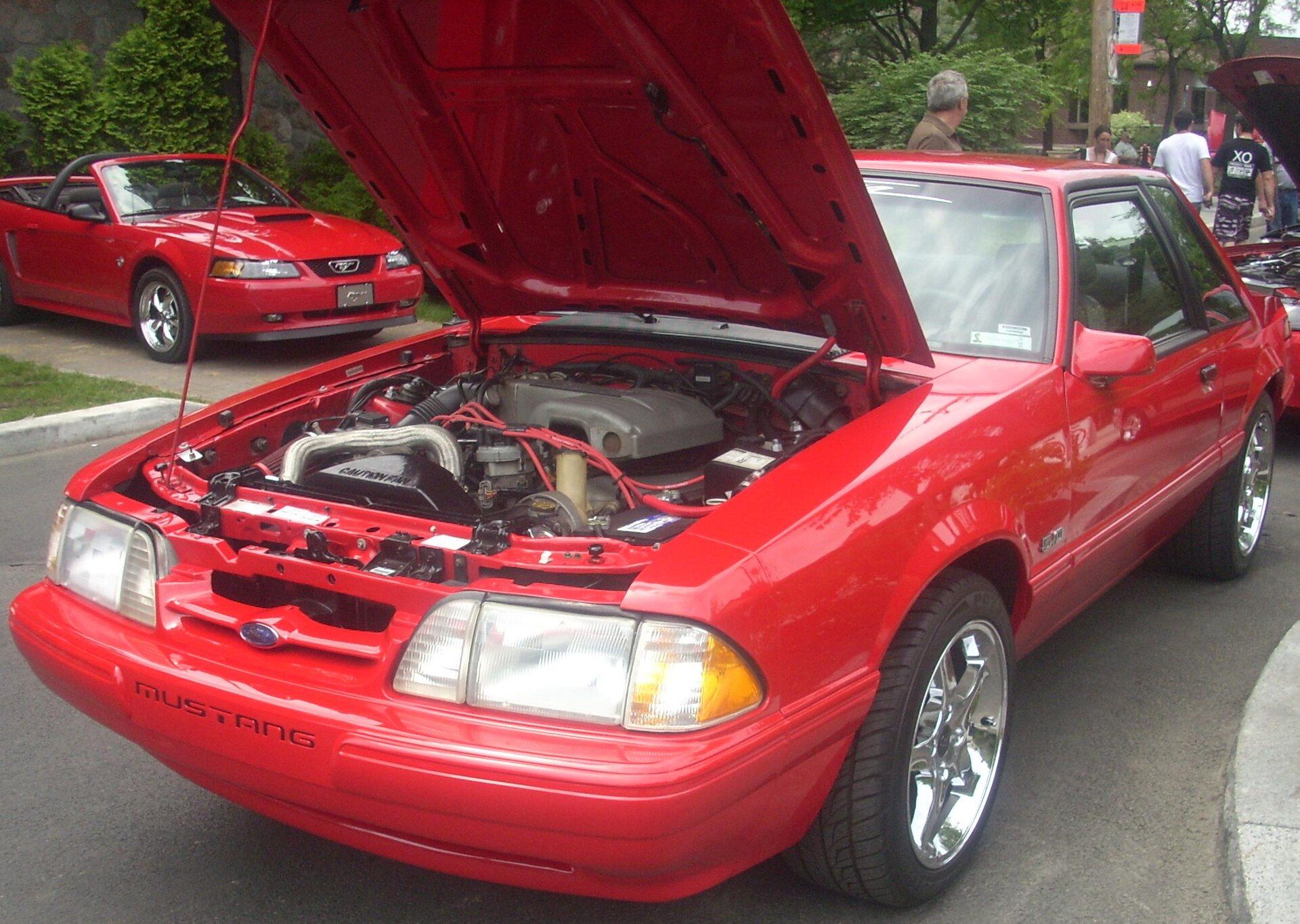 Red 1993 Ford Mustang LX 5.0 coupe photographed from the front right with its hood open