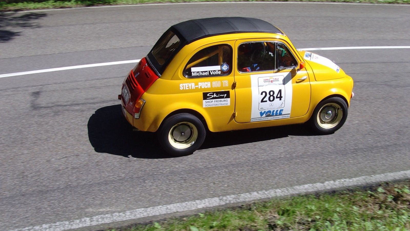 Yellow 1964 Steyr-Puch 650 TR II on a rally stage, side profile