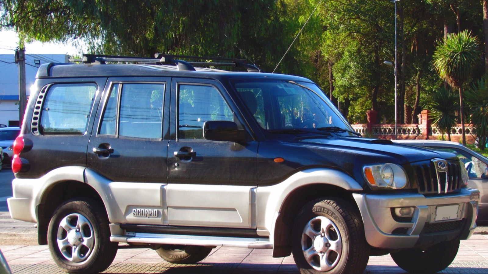Black and silver 2010 Mahindra Scorpio GLX 2.6 m-Hawk parked kerbside, front three-quarter view