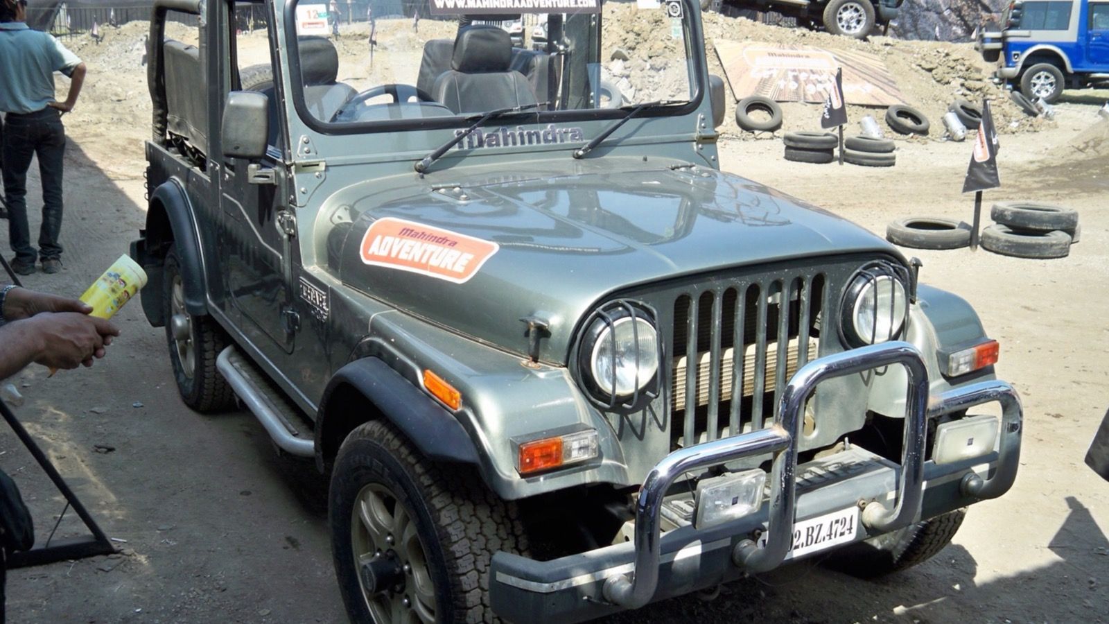 Grey-green 2012 Mahindra Thar soft-top with bull bar at a Mumbai off-road event, front three-quarter view