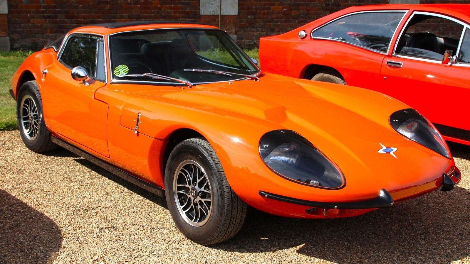 Orange 1971 Marcos GT 3000 coupe, front three-quarter view