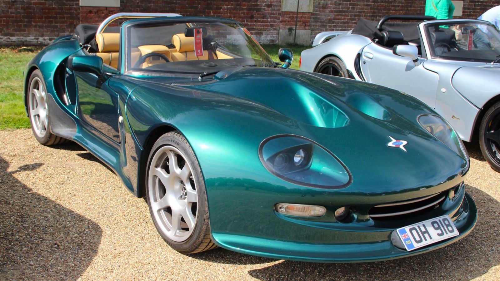 Green Marcos Mantis with the roof down, front three-quarter view