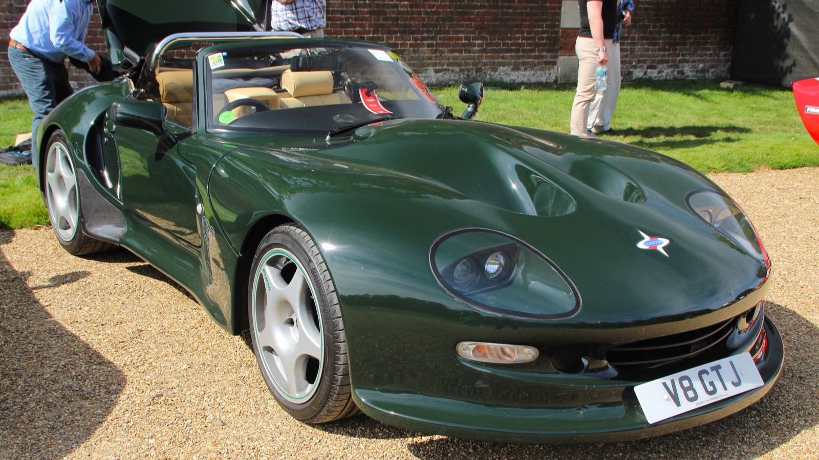 Dark green 2000 Marcos Mantis GT with the roof down, front three-quarter view