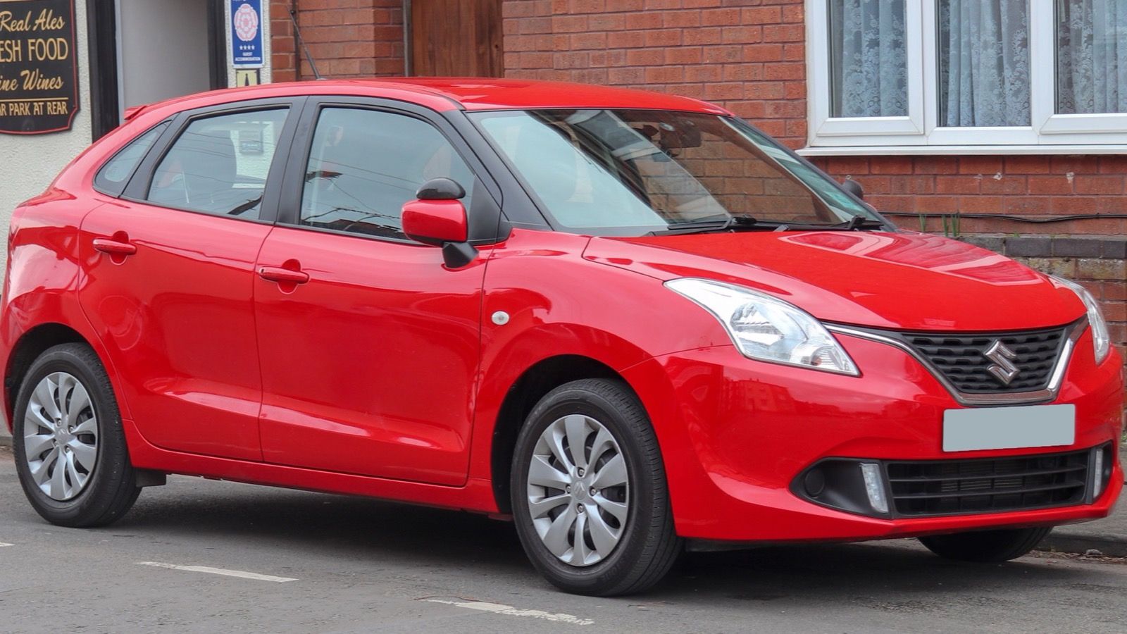 Red 2017 Suzuki Baleno Dualjet hatchback, front three-quarter view