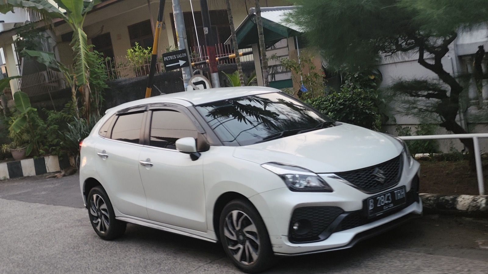 White Suzuki Baleno hatchback, front three-quarter view