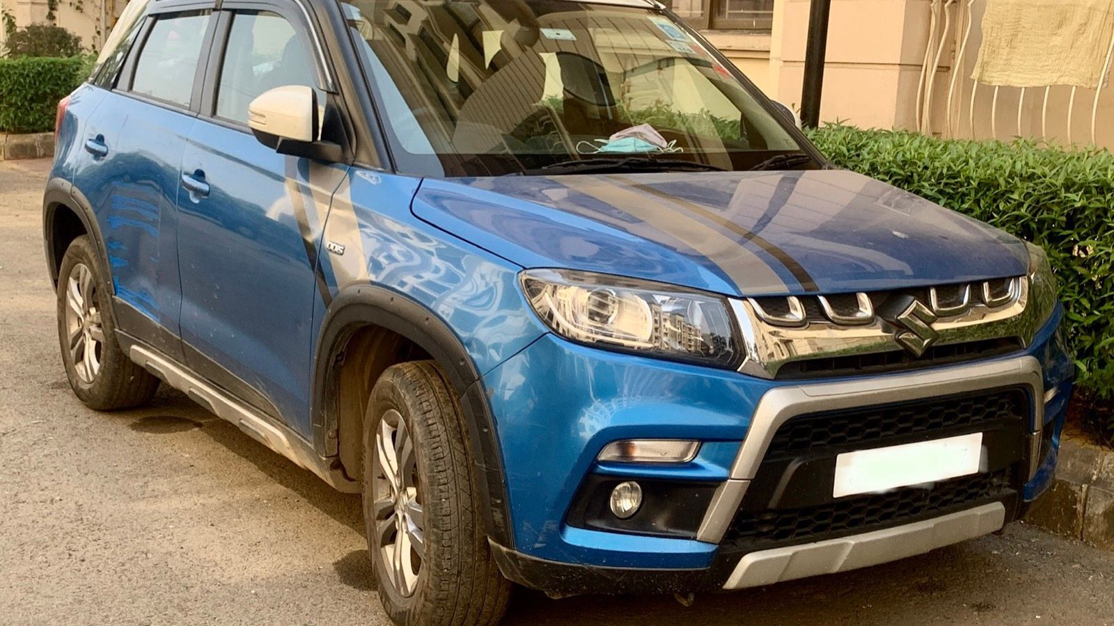 Blue Maruti Suzuki Vitara Brezza ZDi+ compact SUV, front three-quarter view