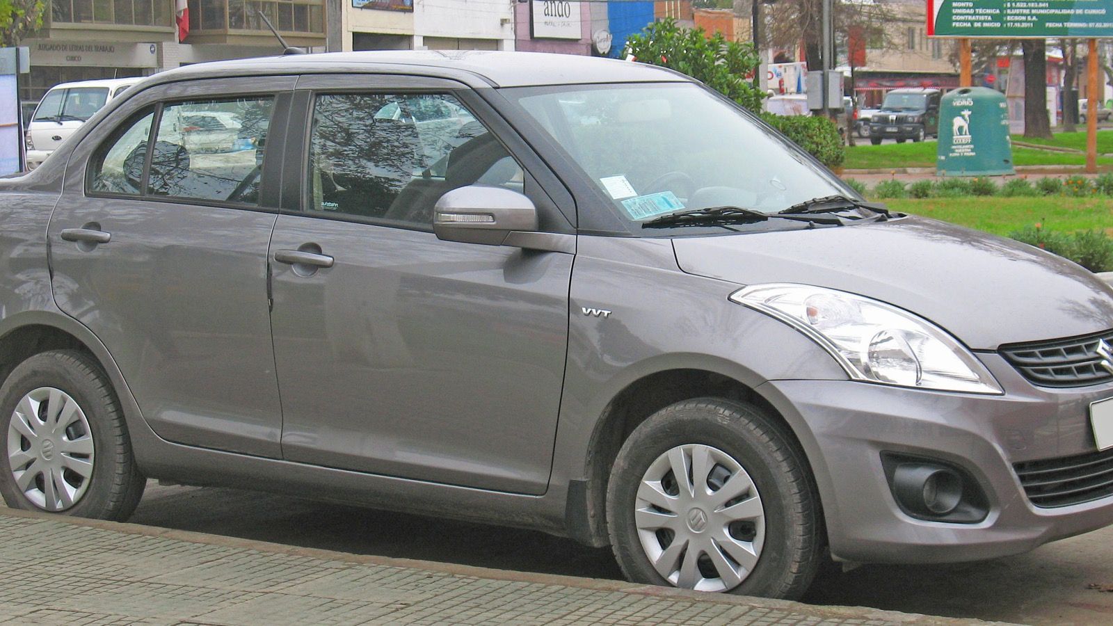 Grey 2013 Suzuki Swift Dzire compact sedan, front three-quarter view