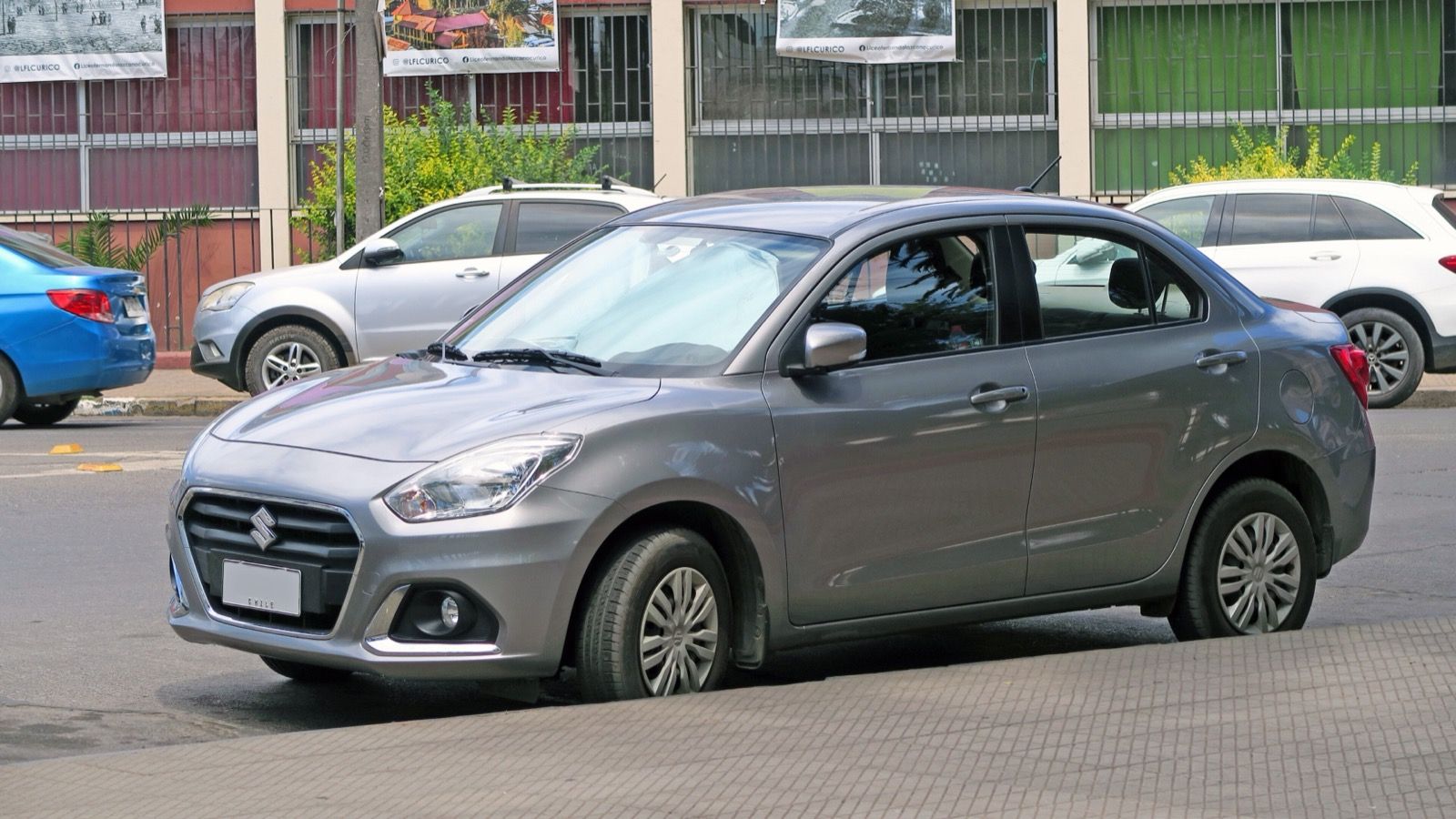 Grey 2022 Suzuki Dzire compact sedan, front three-quarter view
