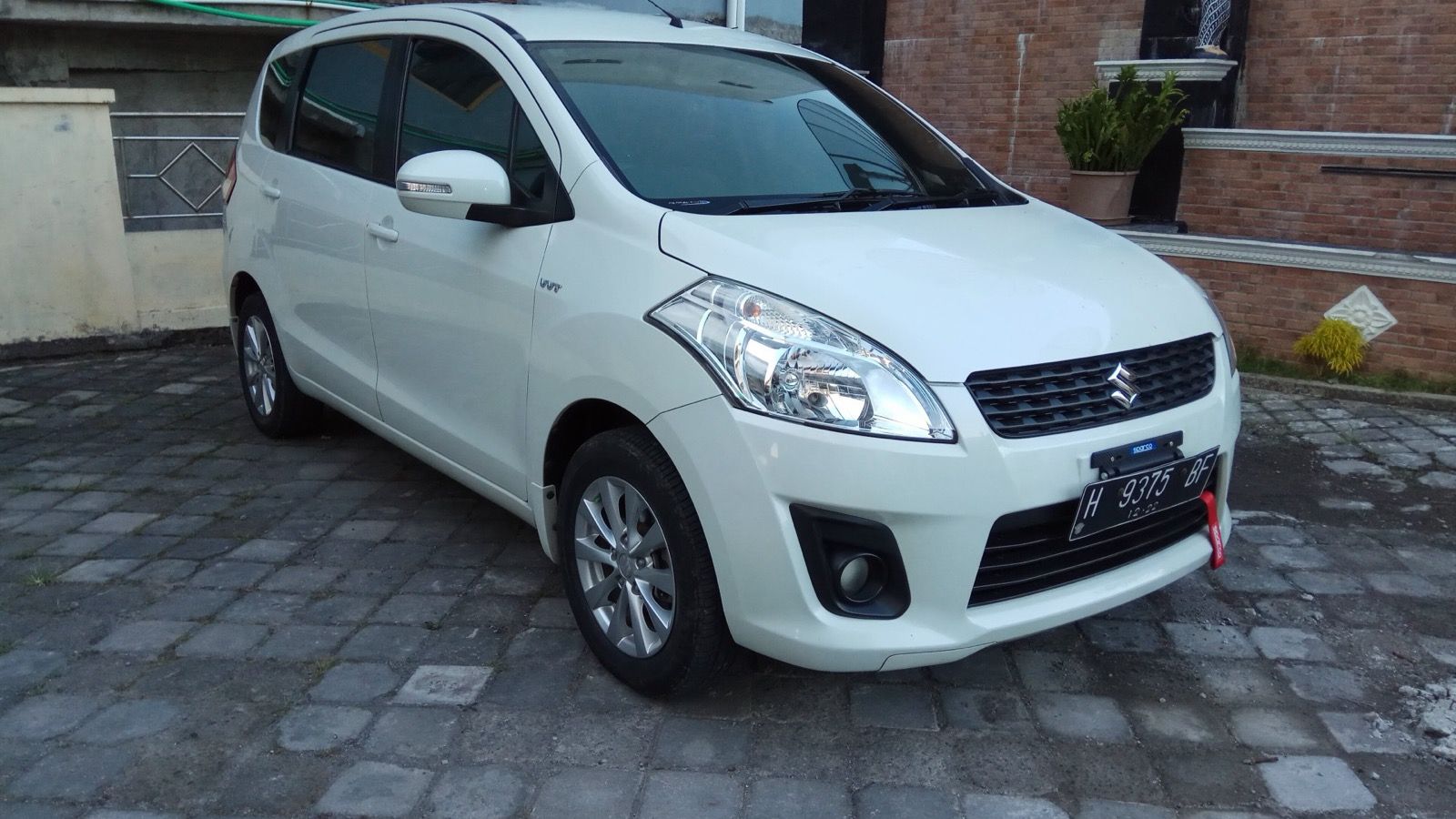 White 2012 Suzuki Ertiga GX compact MPV, front three-quarter view