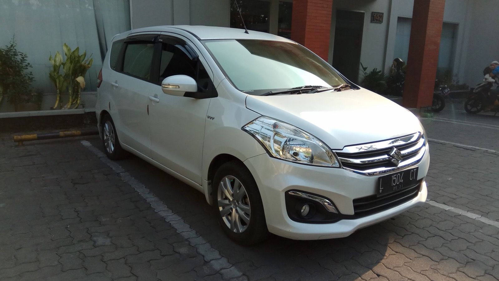 White 2016 Suzuki Ertiga GX facelift compact MPV, front three-quarter view