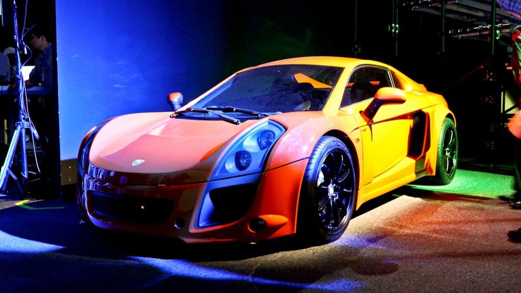 Orange Mastretta MXT displayed under stage lighting at Campus Party Mexico 2011, front three-quarter view