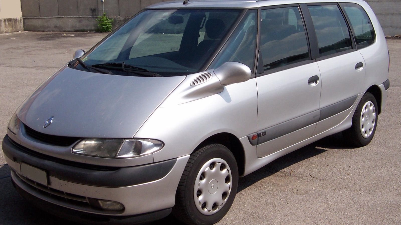Silver 1998 third-generation Renault Espace parked on a paved lot, front three-quarter view