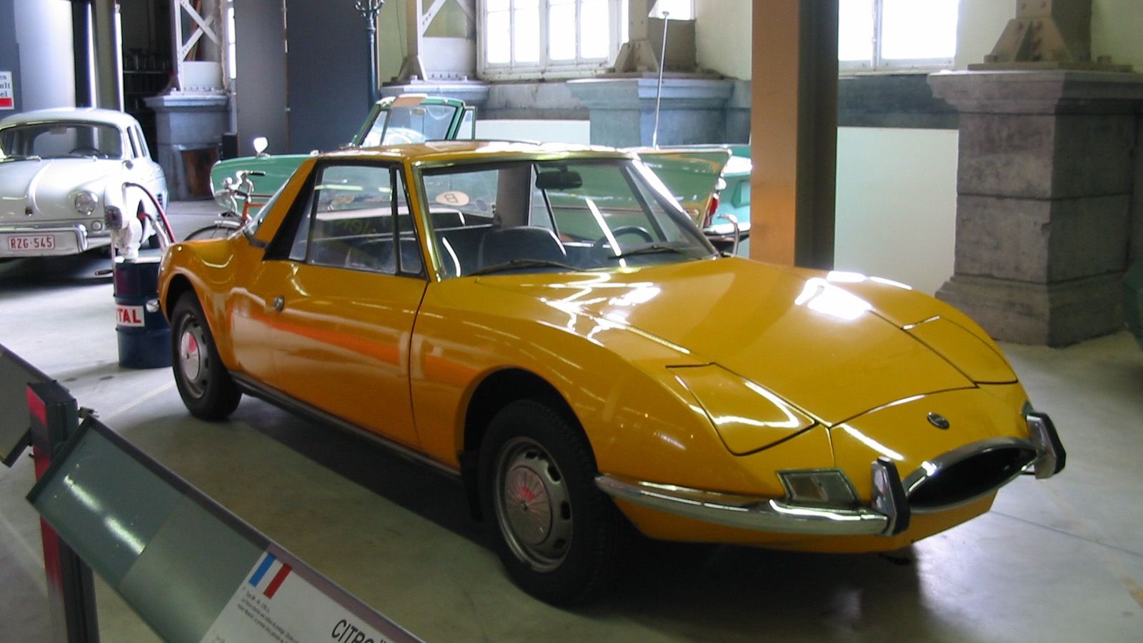 Orange 1971 Matra 530 LX in a museum display hall, front three-quarter view