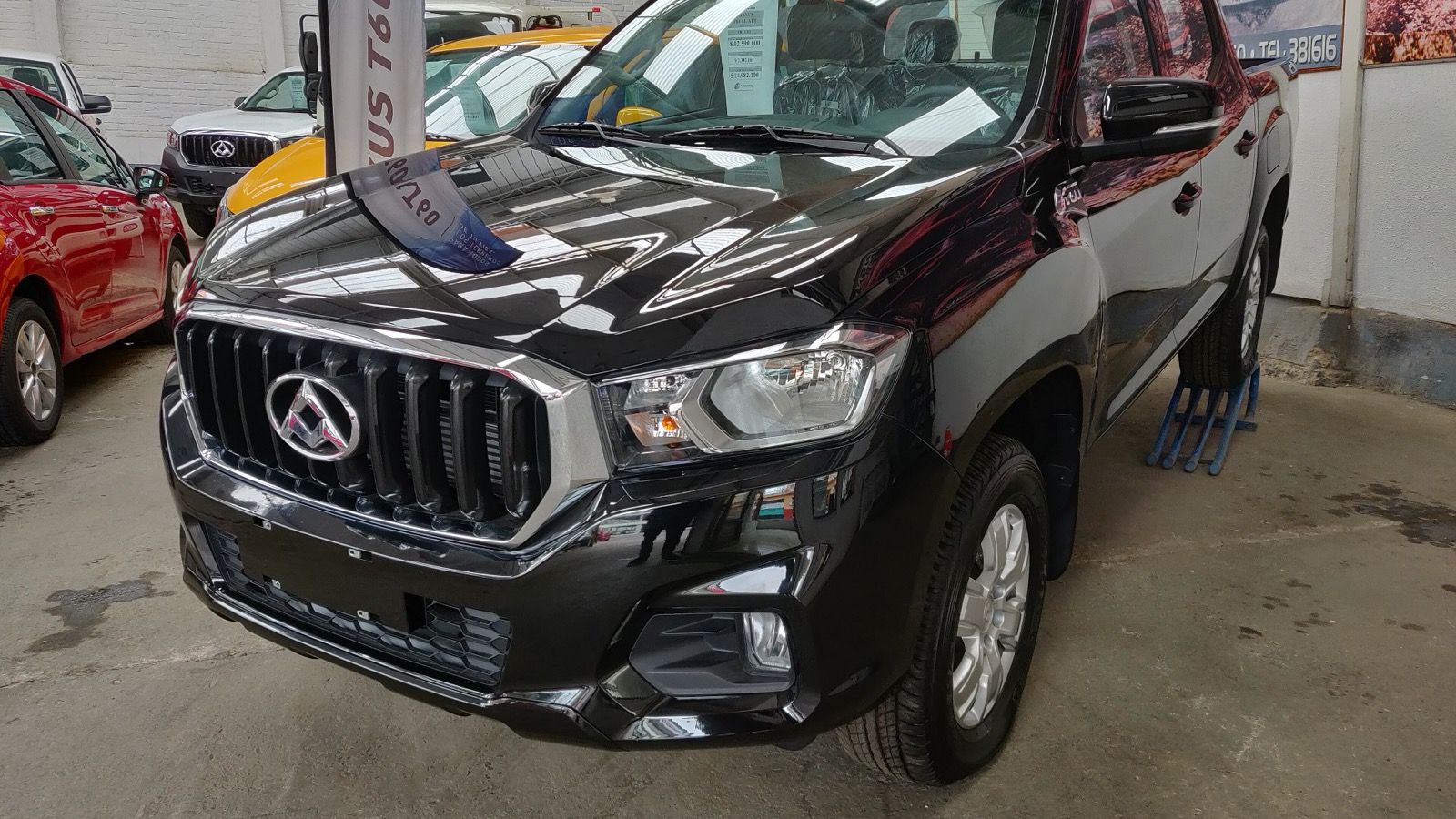 Black 2019 Maxus T60 double-cab pickup at a Chilean dealership, front three-quarter view