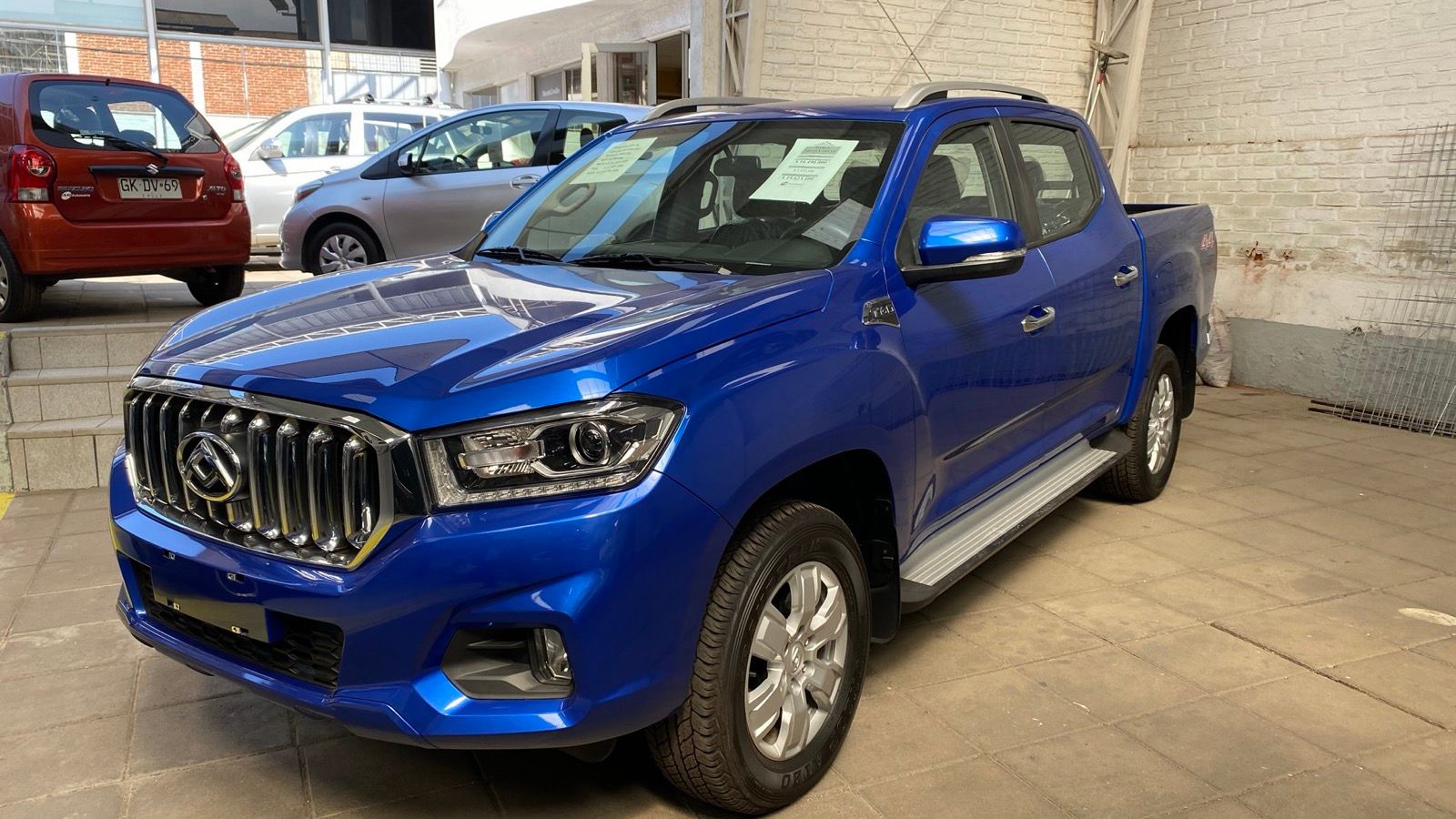 Blue 2020 Maxus T60 GLX double-cab pickup in a showroom, front three-quarter view