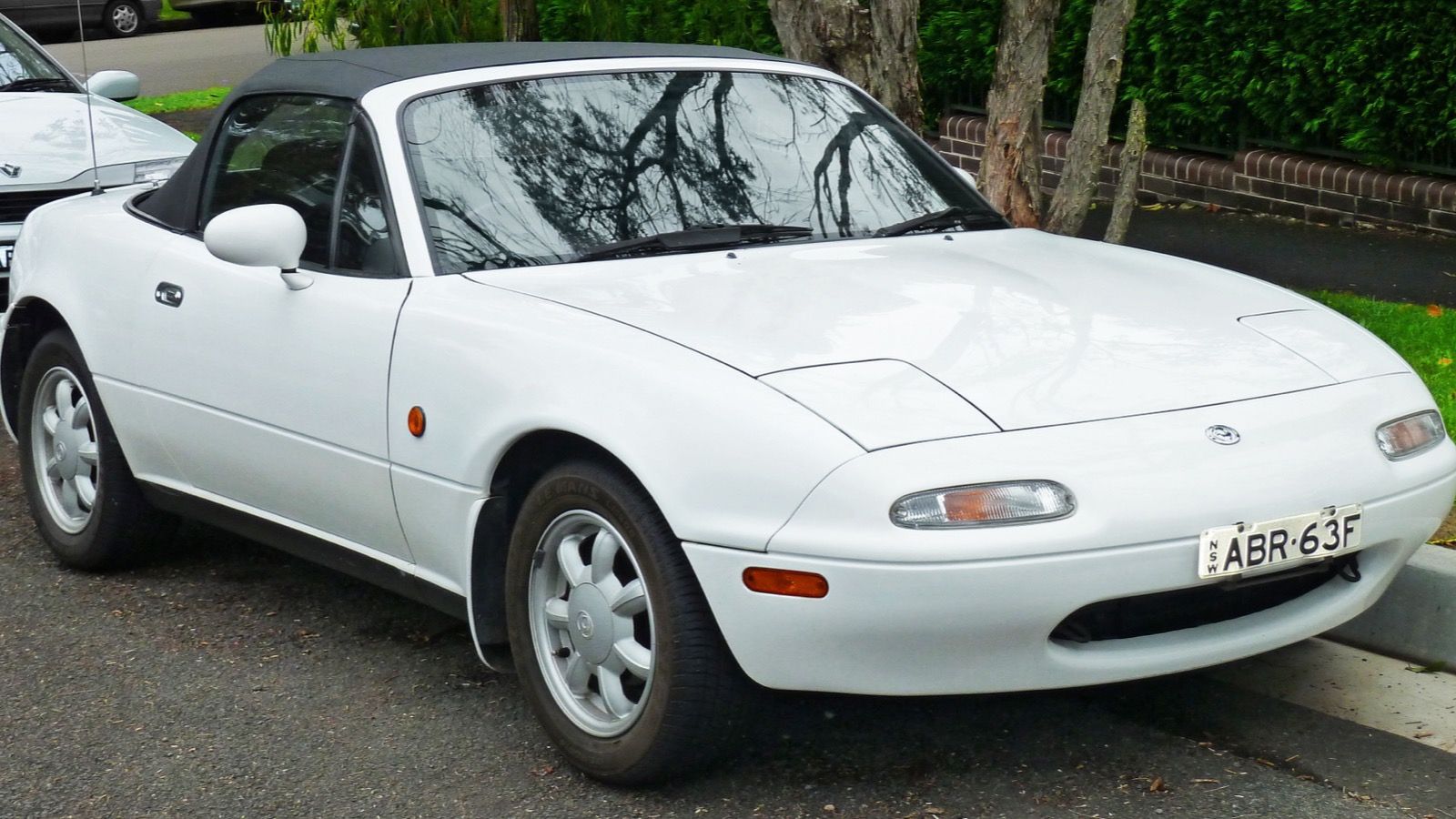 1992 Mazda MX-5 Miata, NA first generation — red roadster, side view