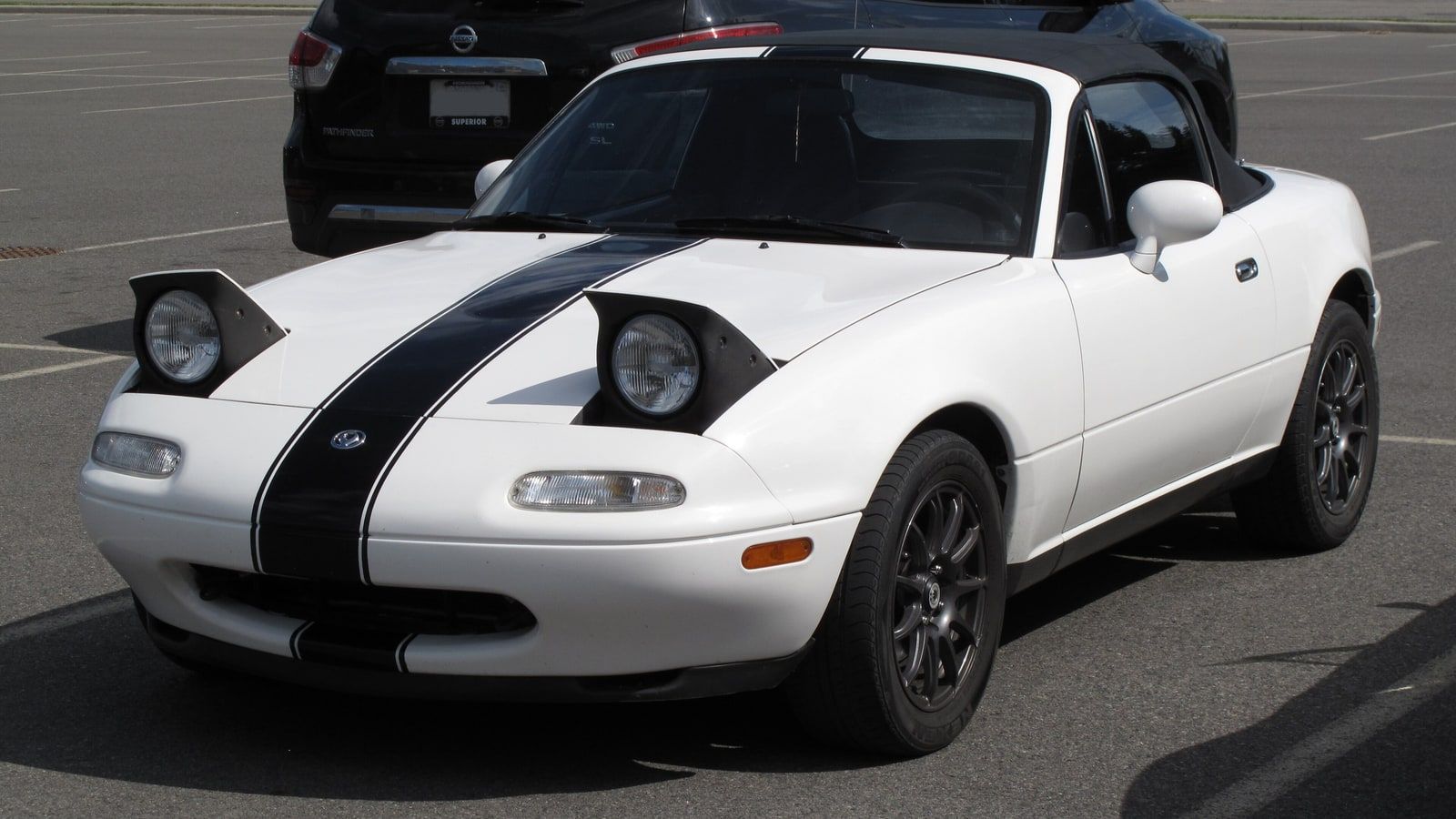 1994 Mazda MX-5 Miata, NA first generation — red roadster, front three-quarter view