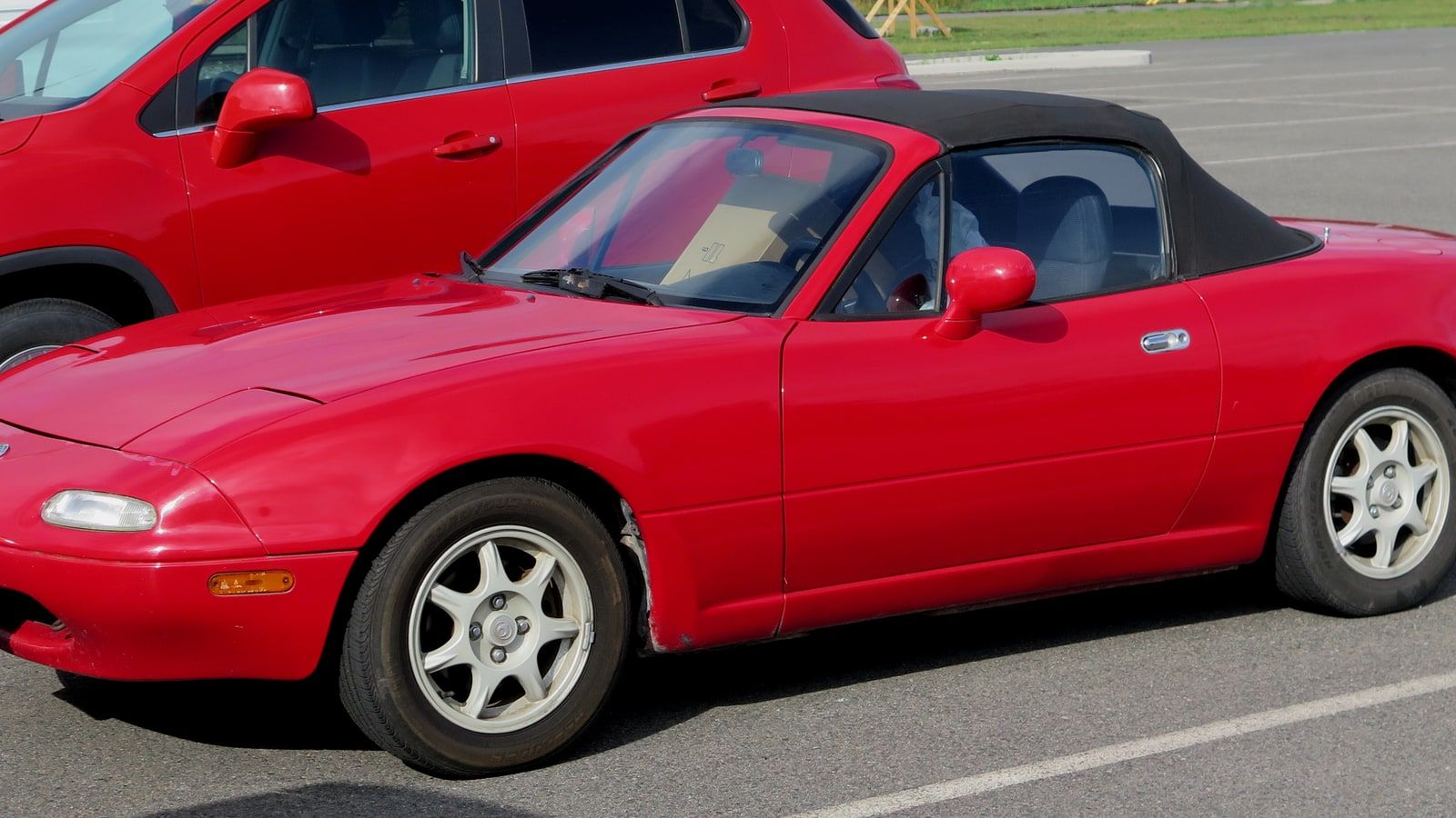 1995 Mazda MX-5 Miata, NA first generation — Classic Red roadster, front three-quarter view
