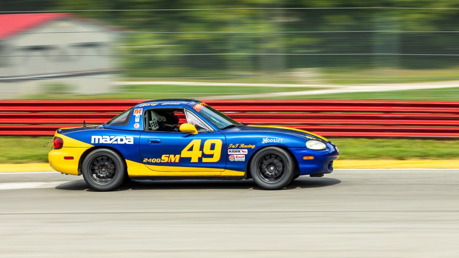 1999 Mazda MX-5 Miata, NB second generation — blue-and-yellow Spec Miata race car, side view